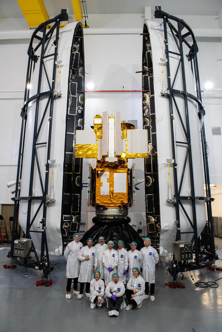 Inside the SpaceX facility at Vandenberg Space Force Base in California, both halves of the SpaceX Falcon 9 payload fairing are moved to enclose the Surface Water and Ocean Topography (SWOT) satellite on Dec. 8, 2022. To mark the milestone, members of the processing team gather in front of the SWOT satellite. A collaboration between NASA and the French space agency Centre National d’Études Spatiales (CNES), with contributions from the Canadian Space Agency and the UK Space Agency, SWOT will be the first satellite to survey nearly all water on Earth’s surface. SWOT is scheduled to lift off aboard the SpaceX Falcon 9 rocket from Vandenberg on Dec. 15, 2022, at 3:46 a.m. PST. 