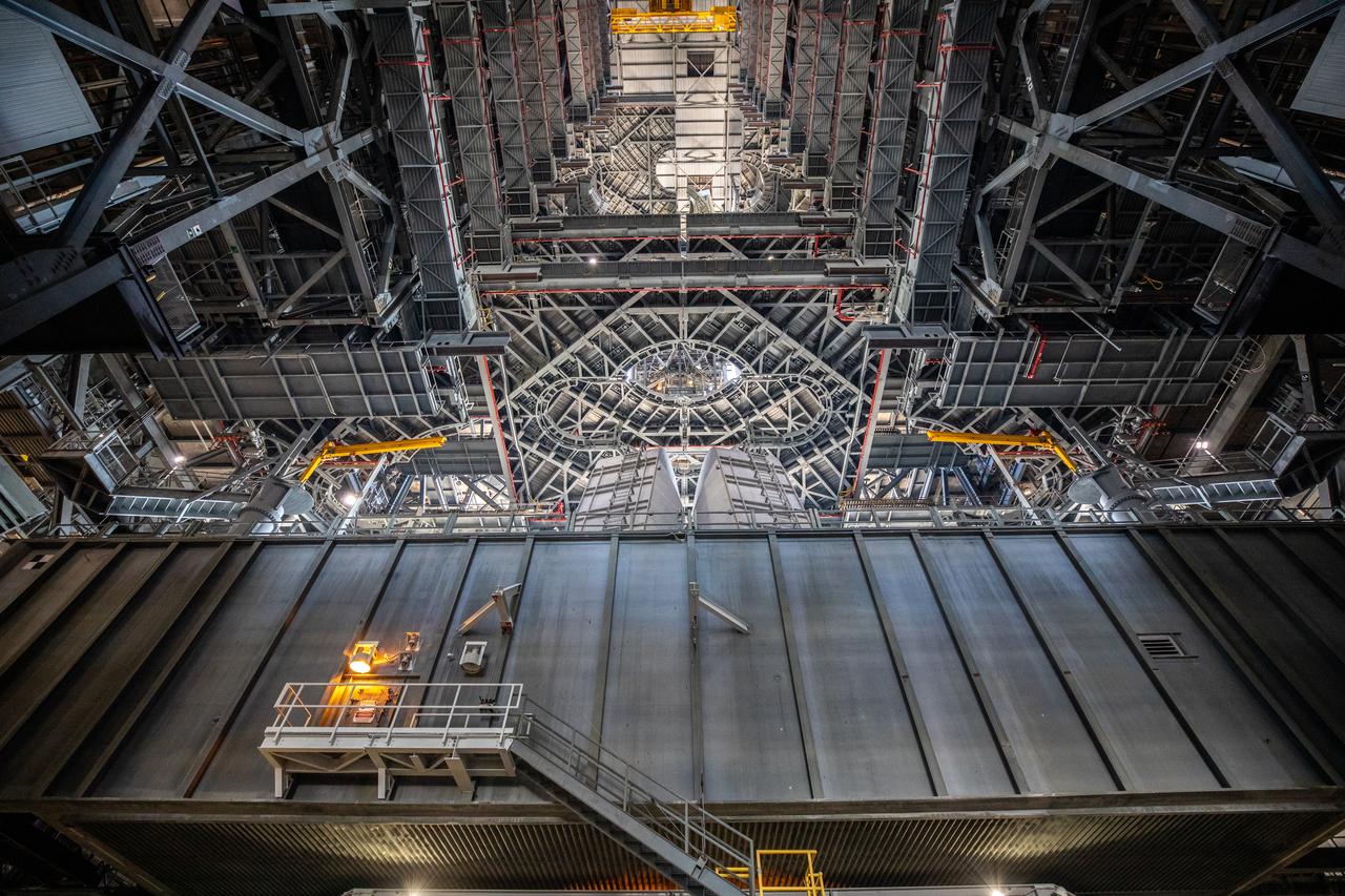 NASA’s mobile launcher, carried atop the crawler-transporter 2, is moved inside High Bay 3 of the Vehicle Assembly Building (VAB) at NASA’s Kennedy Space Center in Florida on Dec. 9, 2022, following the successful launch of the agency’s Space Launch System (SLS) rocket and Orion spacecraft on the Artemis I flight test on Nov. 16, 2022. The mobile launcher will remain inside the VAB for several weeks as teams get it ready for the Artemis II crewed mission. Following its stay in the VAB, it will go to the mobile launcher park site location at Kennedy where it will undergo emergency egress modifications and testing to support future Artemis missions. 