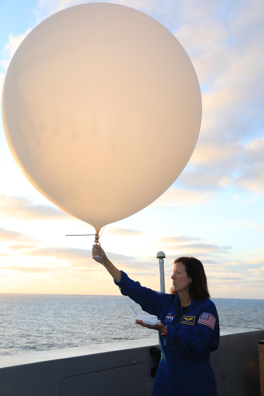 Astronaut Shannon Walker prepares to release a weather balloon from the deck of the USS Portland alongside members of the U.S. Space Force 45th Weather Squadron ahead of the splashdown of the Orion spacecraft on Dec. 11. NASA's Landing and Recovery team works alongside the DoD to safely recover Orion after Artemis missions to the Moon.
