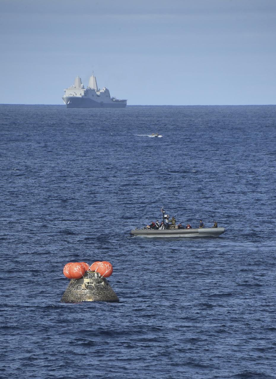 At 12:40 p.m. EST, Dec. 11, 2022, NASA’s Orion spacecraft for the Artemis I mission splashed down in the Pacific Ocean with the USS Portland seen in the distance after a 25.5 day mission to the Moon. Orion will be recovered by NASA’s Landing and Recovery team, U.S. Navy and Department of Defense partners aboard the USS Portland.