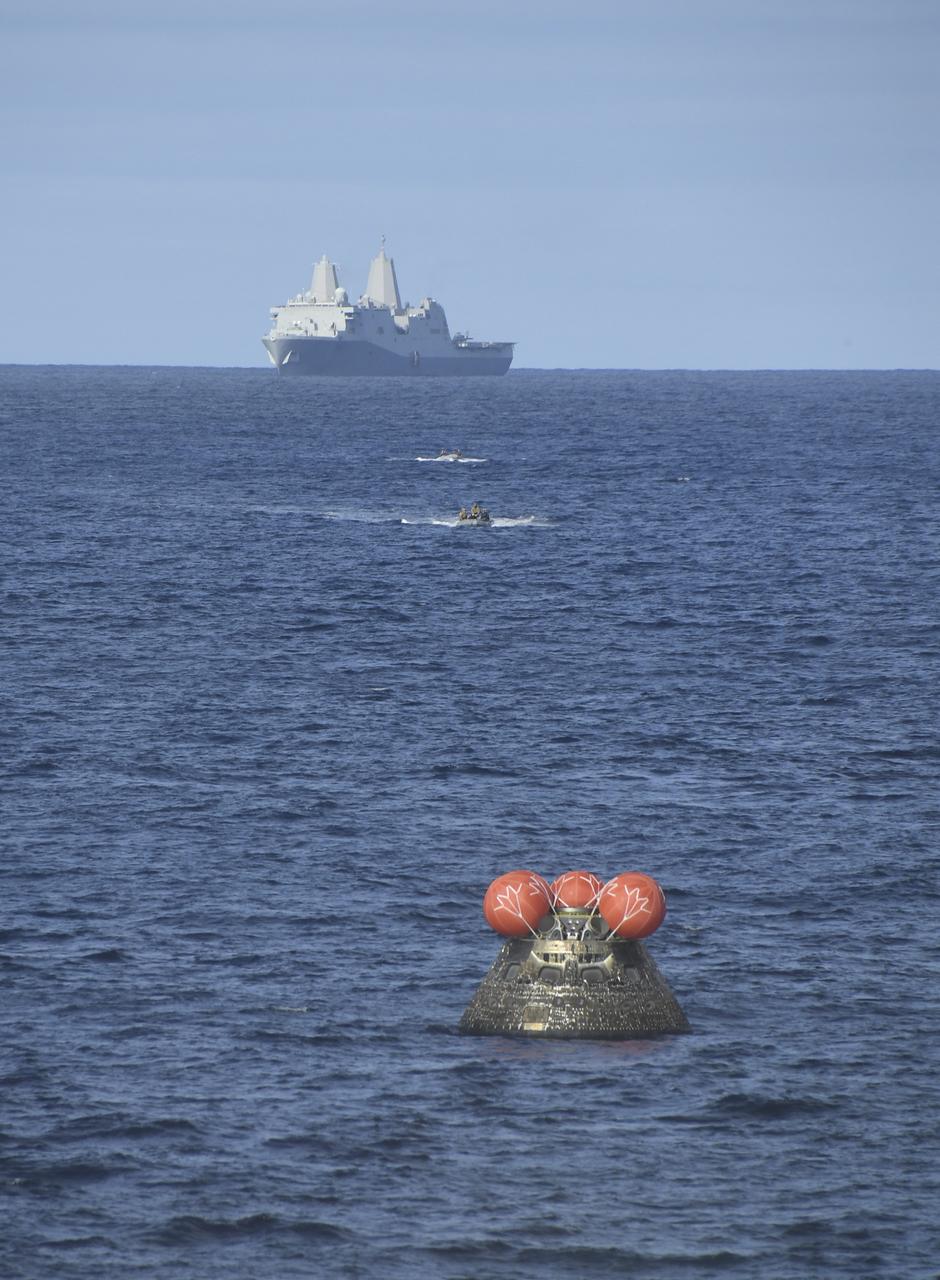 At 12:40 p.m. EST, Dec. 11, 2022, NASA’s Orion spacecraft for the Artemis I mission splashed down in the Pacific Ocean with the USS Portland seen in the distance after a 25.5 day mission to the Moon. Orion will be recovered by NASA’s Landing and Recovery team, U.S. Navy and Department of Defense partners aboard the USS Portland.