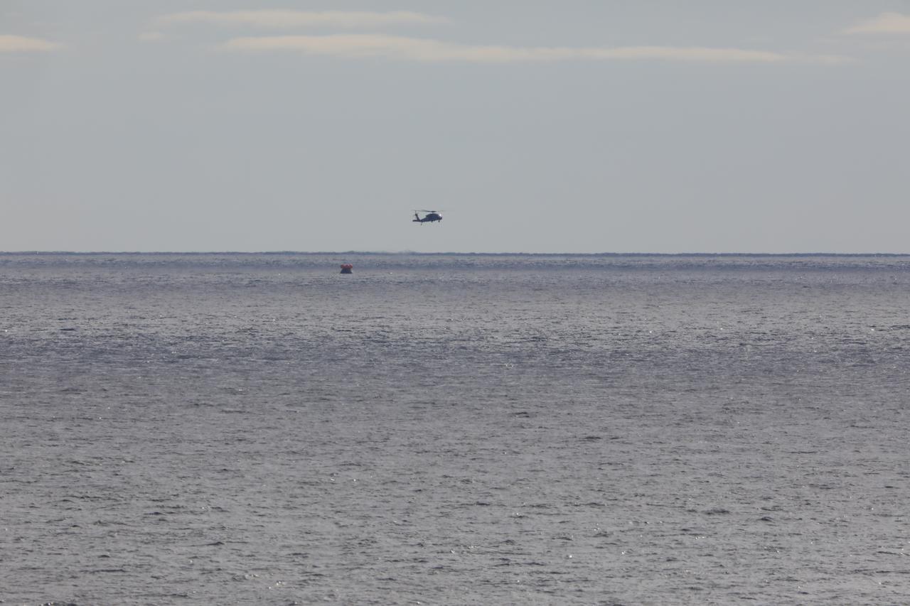 Helicopters and Navy divers surround NASA’s Orion spacecraft after it splashed down at 12:40 p.m. EST Dec. 11, 2022 in the Pacific Ocean after a 25.5 day mission to the Moon. Orion will be recovered by NASA’s Landing and Recovery team, U.S. Navy and Department of Defense partners aboard the USS Portland.