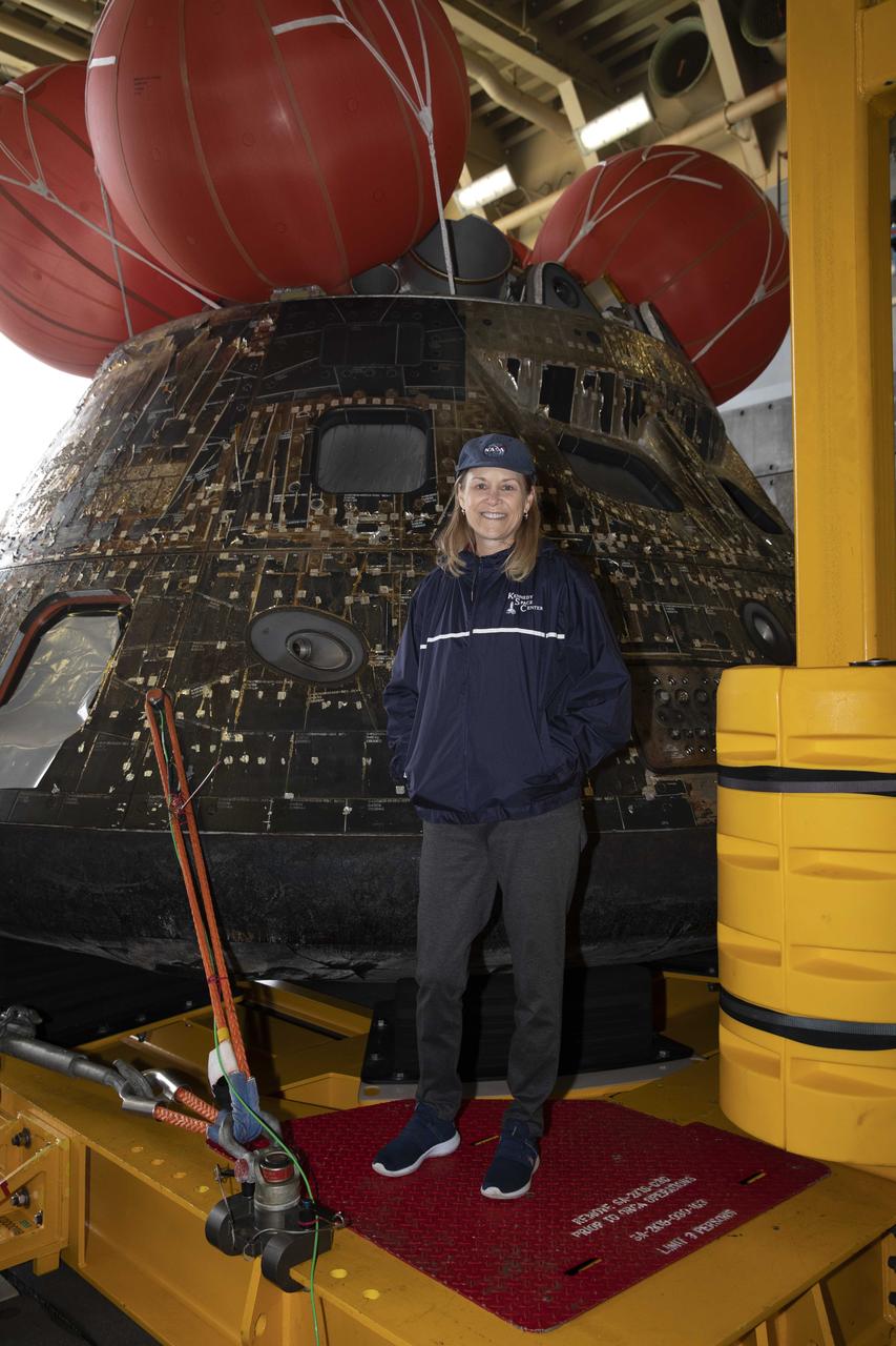 Kennedy Space Center Director Janet Petro stands near the Artemis I Orion spacecraft inside the well deck of the USS Portland at U.S. Naval Base San Diego on Dec. 13, 2022. The Orion spacecraft is secured inside the well deck after splashing down at 12:40 p.m. EST on Dec. 11, 2022. U.S. Navy divers helped recover the Orion spacecraft. NASA, the Navy and other Department of Defense partners worked together to secure the spacecraft inside the ship’s well deck approximately five hours after Orion splashed down in the Pacific Ocean off the coast of Baja, California. 