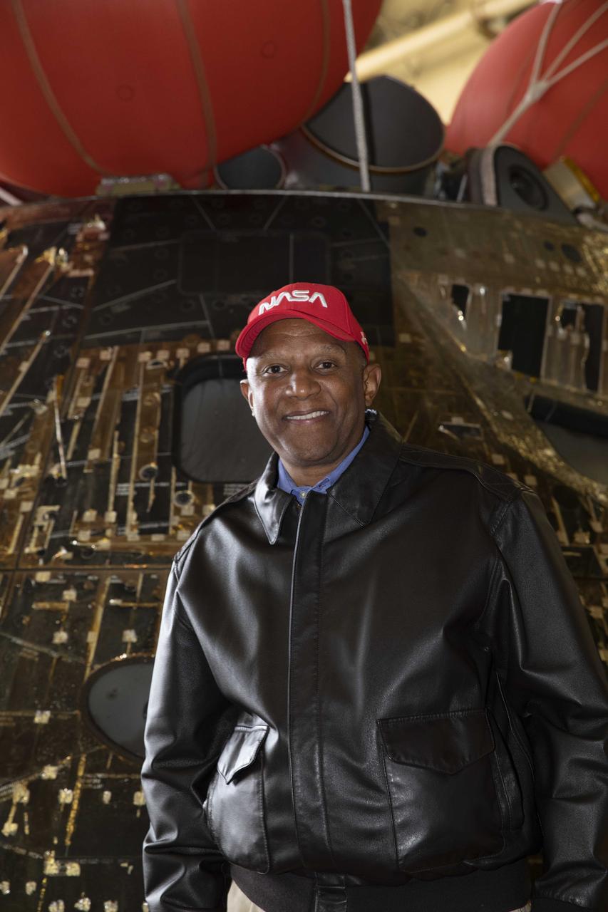 Kennedy Space Center Deputy Director Kelvin Manning stands near the Artemis I Orion spacecraft inside the well deck of the USS Portland at U.S. Naval Base San Diego on Dec. 13, 2022. The Orion spacecraft is secured inside the well deck after splashing down at 12:40 p.m. EST on Dec. 11, 2022. U.S. Navy divers helped recover the Orion spacecraft. NASA, the Navy and other Department of Defense partners worked together to secure the spacecraft inside the ship’s well deck approximately five hours after Orion splashed down in the Pacific Ocean off the coast of Baja, California. 