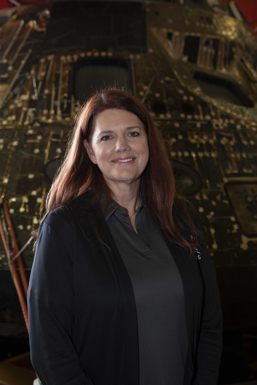 NASA Artemis Launch Director Charlie Blackwell-Thompson, with the Exploration Ground Systems program, stands near the Artemis I Orion spacecraft inside the well deck of the USS Portland at U.S. Naval Base San Diego on Dec. 13, 2022. The Orion spacecraft is secured inside the well deck after splashing down at 12:40 p.m. EST on Dec. 11, 2022. U.S. Navy divers helped recover the Orion spacecraft. NASA, the Navy and other Department of Defense partners worked together to secure the spacecraft inside the ship’s well deck approximately five hours after Orion splashed down in the Pacific Ocean off the coast of Baja, California. 