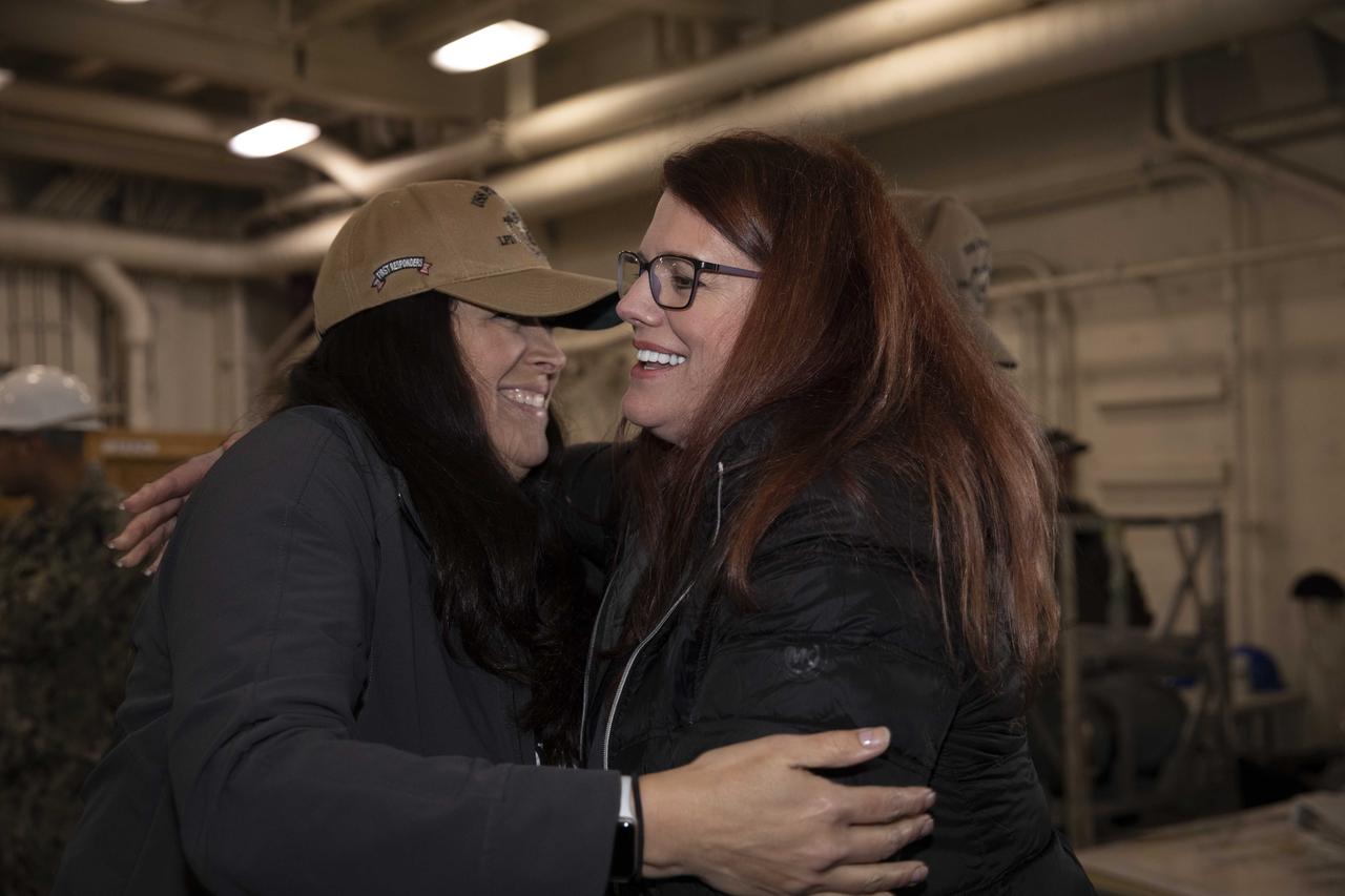 NASA Artemis Launch Director Charlie Blackwell-Thompson, at right, and Melissa Jones, NASA’s Artemis I Recovery director, both with the Exploration Ground Systems program, exchange congratulations inside the well deck of the USS Portland at U.S. Naval Base San Diego on Dec. 13, 2022. The Orion spacecraft is secured inside the well deck after splashing down at 12:40 p.m. EST on Dec. 11, 2022. U.S. Navy divers helped recover the Orion spacecraft. NASA, the Navy and other Department of Defense partners worked together to secure the spacecraft inside the ship’s well deck approximately five hours after Orion splashed down in the Pacific Ocean off the coast of Baja, California. 
