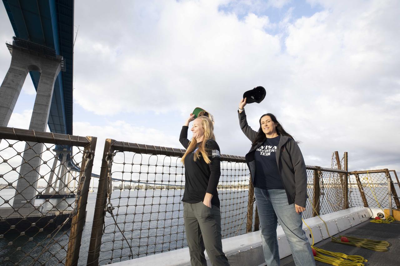 While returning to port after successfully recovering the Orion spacecraft for the Artemis I mission, NASA Artemis Recovery Director Melissa Jones, at right, and Assistant NASA Recovery Director Carla Rekucki, throw their hats in the air aboard the USS Portland as they pass under the San Diego-Coronado bridge on Dec. 13, 2022. The Artemis I Orion spacecraft is secured inside the ship’s well deck after splashing down at 12:40 p.m. EST on Dec. 11, 2022. U.S. Navy divers helped recover the Orion spacecraft. NASA, the Navy and other Department of Defense partners worked together to secure the spacecraft inside the ship’s well deck approximately five hours after Orion splashed down in the Pacific Ocean off the coast of Baja, California. 
