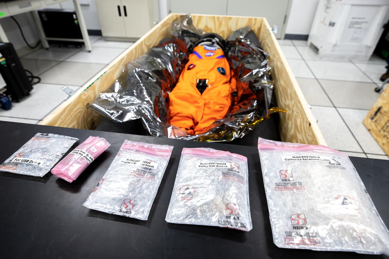 Commander Moonikin Campos, a sensored stand-in for humans from NASA’s Artemis I mission, is packed within its transport crate inside the Space Station Processing Facility at Kennedy Space Center in Florida on Jan. 10, 2023, for its trip back to NASA’s Johnson Space Center in Houston. In the foreground are packages of seeds that rode with Moonikin Campos secured inside the Orion spacecraft for the mission beyond the Moon and back to Earth. Artemis I Orion launched atop the Space Launch System (SLS) rocket from Kennedy’s Launch Complex 39B on Nov. 16, 2022, at 1:47 a.m. EST for a 25-day trip beyond the Moon and back. During the flight, Orion flew farther than any human-rated spacecraft has ever flown, paving the way for human deep space exploration and demonstrating NASA’s commitment and capability to extend human presence to the Moon and beyond. The primary goal of Artemis I was to thoroughly test the SLS and Orion spacecraft’s integrated systems before crewed missions. Under Artemis, NASA aims to land the first woman and first person of color on the Moon and establish sustainable lunar exploration. 
