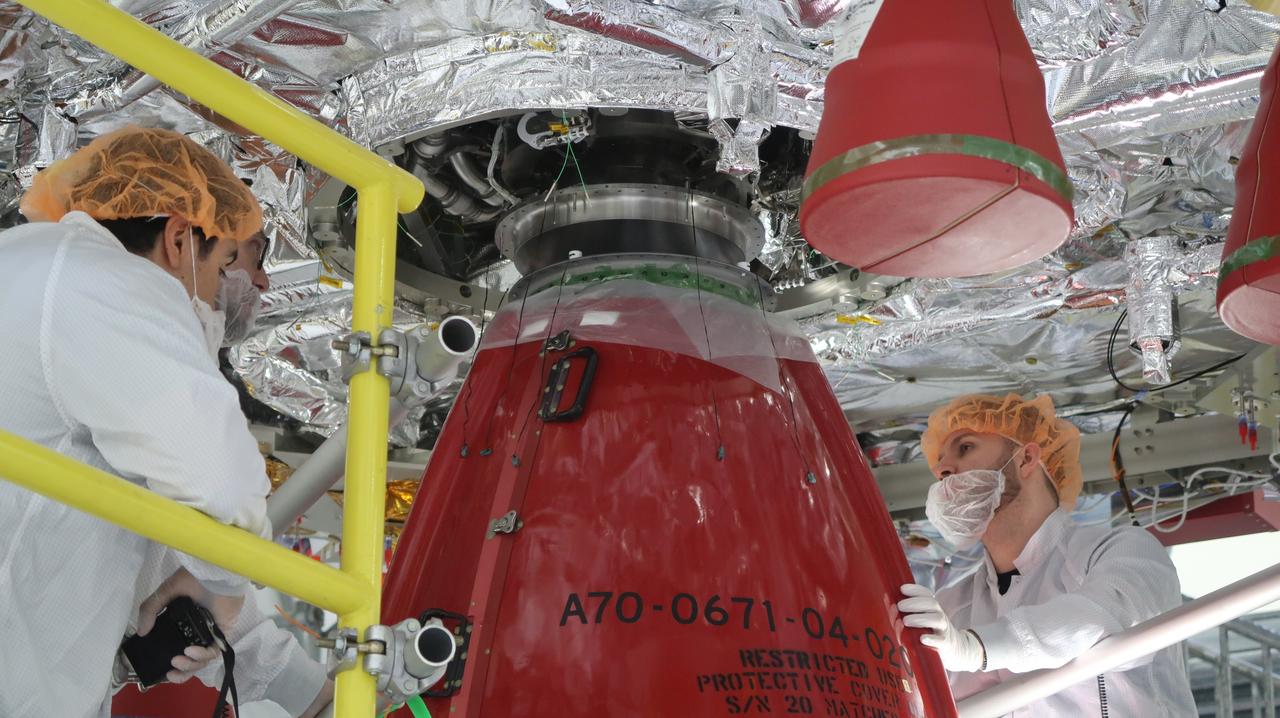 Technicians at NASA’s Kennedy Space Center in Florida install the orbital maneuvering system engine nozzle and heat shield for the Artemis II European Service Module inside the Neil Armstrong Operations and Checkout Building on Jan. 14, 2023. Artemis II will be the first crewed flight test of the Space Launch System rocket and Orion spacecraft. The service module will provide the power necessary to propel Orion on a trip around the Moon, including the in-space maneuvering capability and other commodities necessary to sustain crew for the duration of the mission.