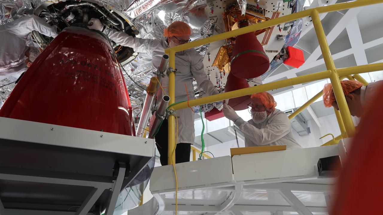 Technicians at NASA’s Kennedy Space Center in Florida install the orbital maneuvering system engine nozzle and heat shield for the Artemis II European Service Module inside the Neil Armstrong Operations and Checkout Building on Jan. 14, 2023. Artemis II will be the first crewed flight test of the Space Launch System rocket and Orion spacecraft. The service module will provide the power necessary to propel Orion on a trip around the Moon, including the in-space maneuvering capability and other commodities necessary to sustain crew for the duration of the mission.