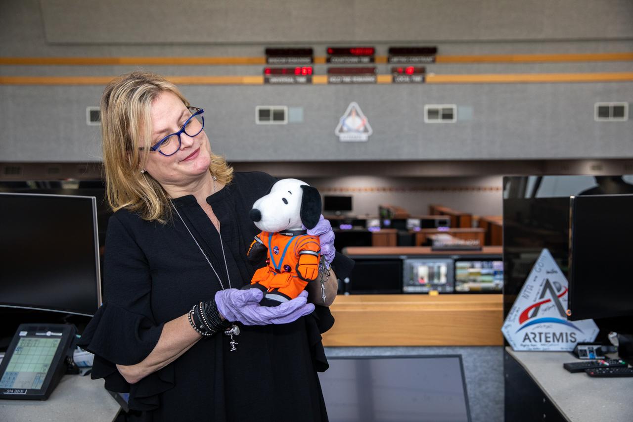 Melissa Menta, senior vice president with Peanuts Worldwide LLC, accepts Snoopy during an official handover from Artemis Launch Director Charlie Blackwell-Thompson inside Launch Control Center Firing Room 1 at NASA’s Kennedy Space Center in Florida on Jan. 18, 2023. Snoopy served as the zero-gravity indicator during the Artemis I mission. Snoopy was secured inside Orion during the mission, a journey beyond the Moon and back to prepare for crewed missions to the Moon. Artemis I launched atop the Space Launch System rocket on Nov. 16, 2022 from Kennedy’s Launch Complex 39B. Orion returned to Earth for a splashdown in the Pacific Ocean on Dec. 11, 2022 after traveling more than 1.4 million miles. NASA has held an association with Snoopy since the Apollo Era – the character has contributed to the excitement for NASA human spaceflight missions, helping inspire generations to dream big, and is a symbol of NASA’s safety culture and mission success. 
