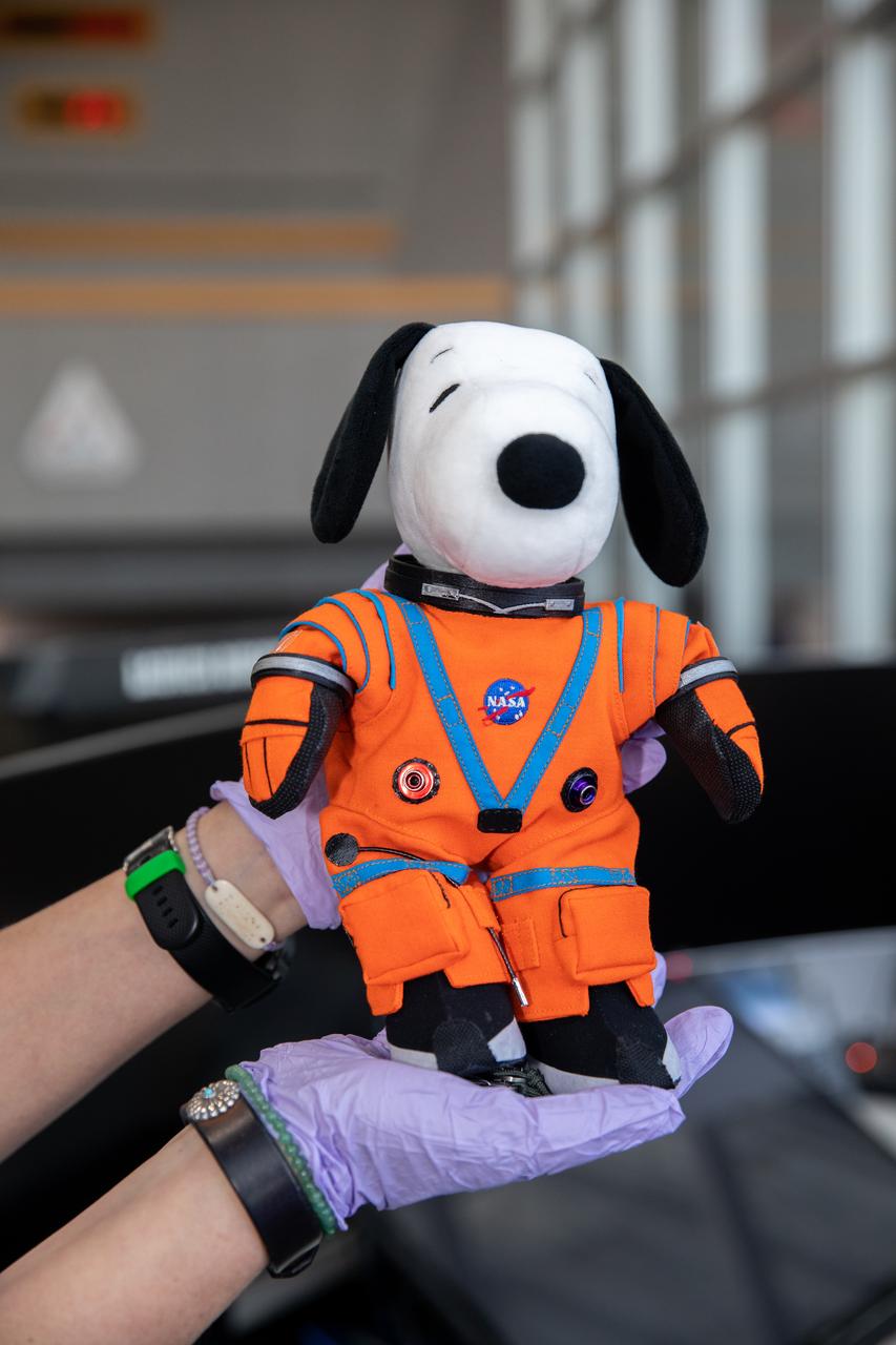 Snoopy is officially handed over to Melissa Menta, senior vice president with Peanuts Worldwide LLC, inside Launch Control Center Firing Room 1 at NASA’s Kennedy Space Center in Florida on Jan. 18, 2023. Snoopy served as the zero-gravity indicator during the Artemis I mission. Snoopy was secured inside Orion during the mission, a journey beyond the Moon and back to prepare for crewed missions to the Moon. Artemis I launched atop the Space Launch System rocket on Nov. 16, 2022 from Kennedy’s Launch Complex 39B. Orion returned to Earth for a splashdown in the Pacific Ocean on Dec. 11, 2022 after traveling more than 1.4 million miles. NASA has held an association with Snoopy since the Apollo Era – the character has contributed to the excitement for NASA human spaceflight missions, helping inspire generations to dream big, and is a symbol of NASA’s safety culture and mission success. 