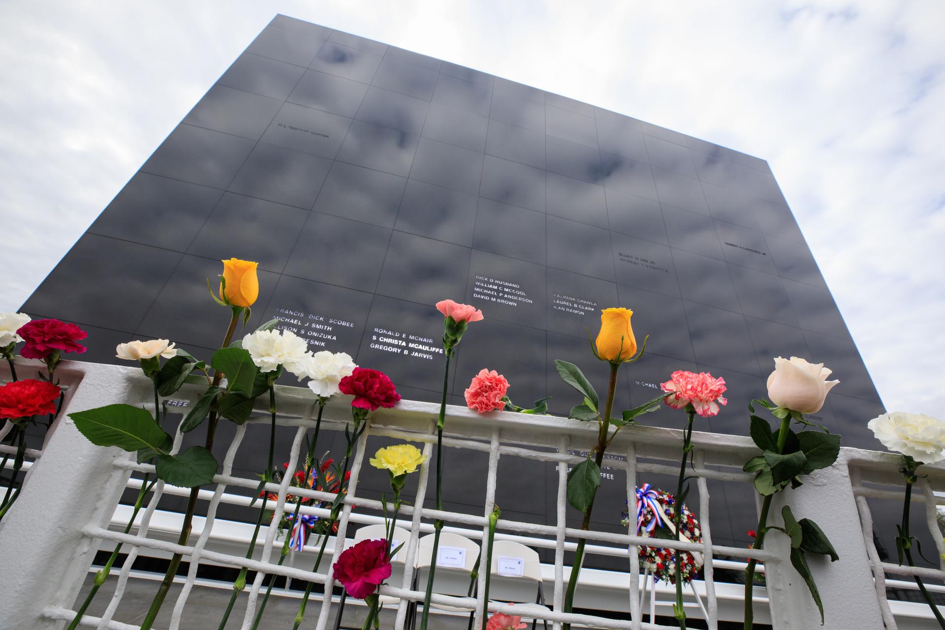 Kennedy Space Center workers and guests placed flowers at the Space Mirror Memorial at the Kennedy Space Center Visitor Complex in Florida during NASA's Day of Remembrance on Jan. 26, 2023. The event honored the crews of Apollo 1 and space shuttles Challenger and Columbia, as well as other astronauts who lost their lives in the pursuit of spaceflight.