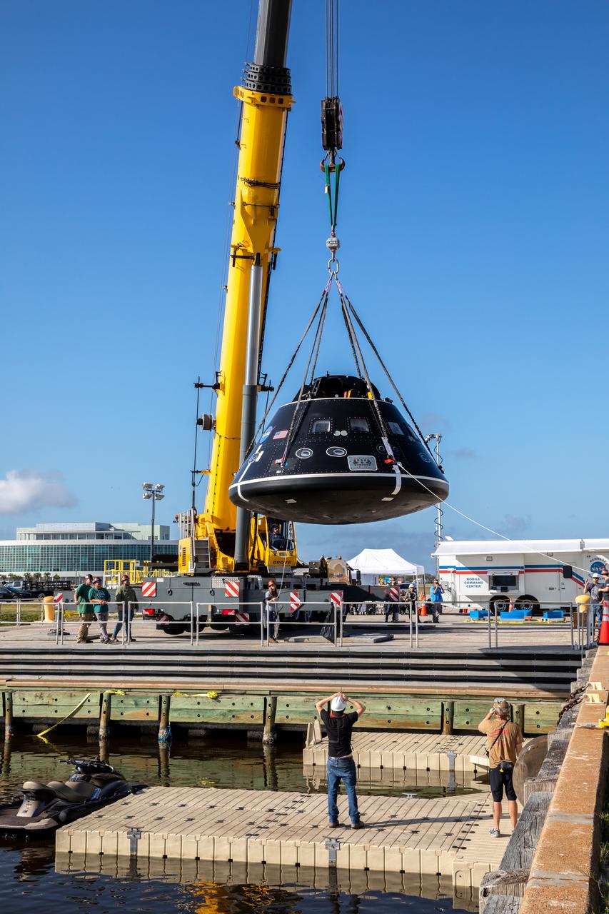 A crane is used to move the Crew Module Test Article (CMTA) above the water at the turn basin in the Launch Complex 39 area at NASA’s Kennedy Space Center in Florida on Jan. 30, 2023. The CMTA is being used to practice recovery after splashdown of the Orion spacecraft to prepare for the Artemis II crewed mission. Exploration Ground Systems leads recovery efforts. 