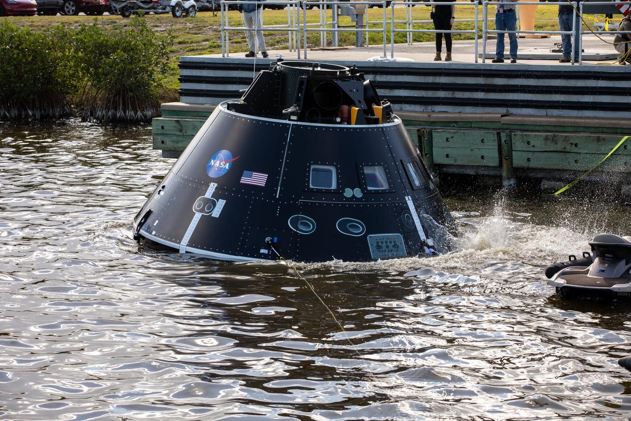 The Crew Module Test Article (CMTA) floats in the water in the turn basin in the Launch Complex 39 area at NASA’s Kennedy Space Center in Florida on Jan. 30, 2023. The CMTA is being used to practice recovery after splashdown of the Orion spacecraft to prepare for the Artemis II crewed mission. Exploration Ground Systems leads recovery efforts. 