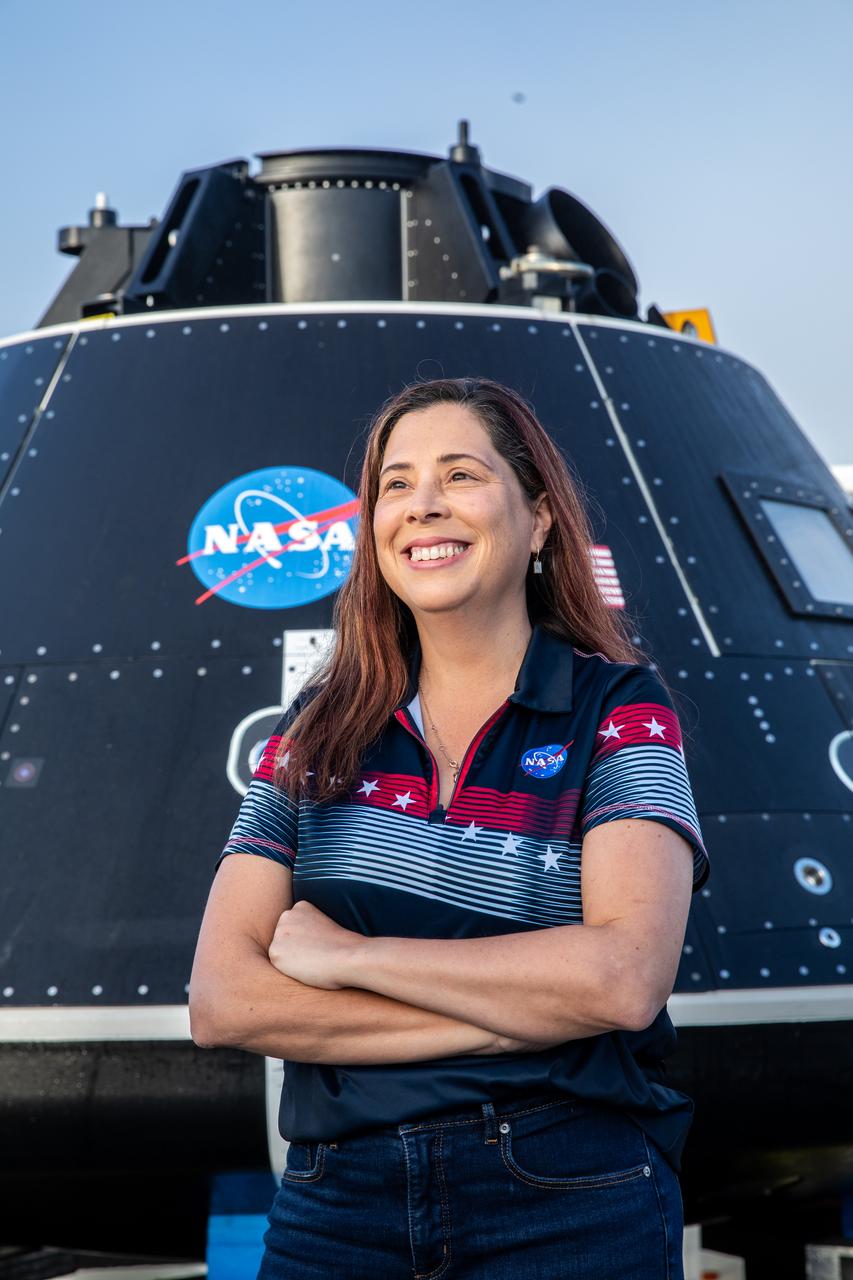 Liliana Villarreal, Artemis landing and recovery director with Exploration Ground Systems (EGS), stands in front of the Crew Module Test Article (CMTA) at the turn basin in the Launch Complex 39 area at NASA’s Kennedy Space Center in Florida on Feb. 1, 2023. The CMTA is being used to practice recovery after splashdown of the Orion spacecraft to prepare for the Artemis II crewed mission. EGS leads recovery efforts. 