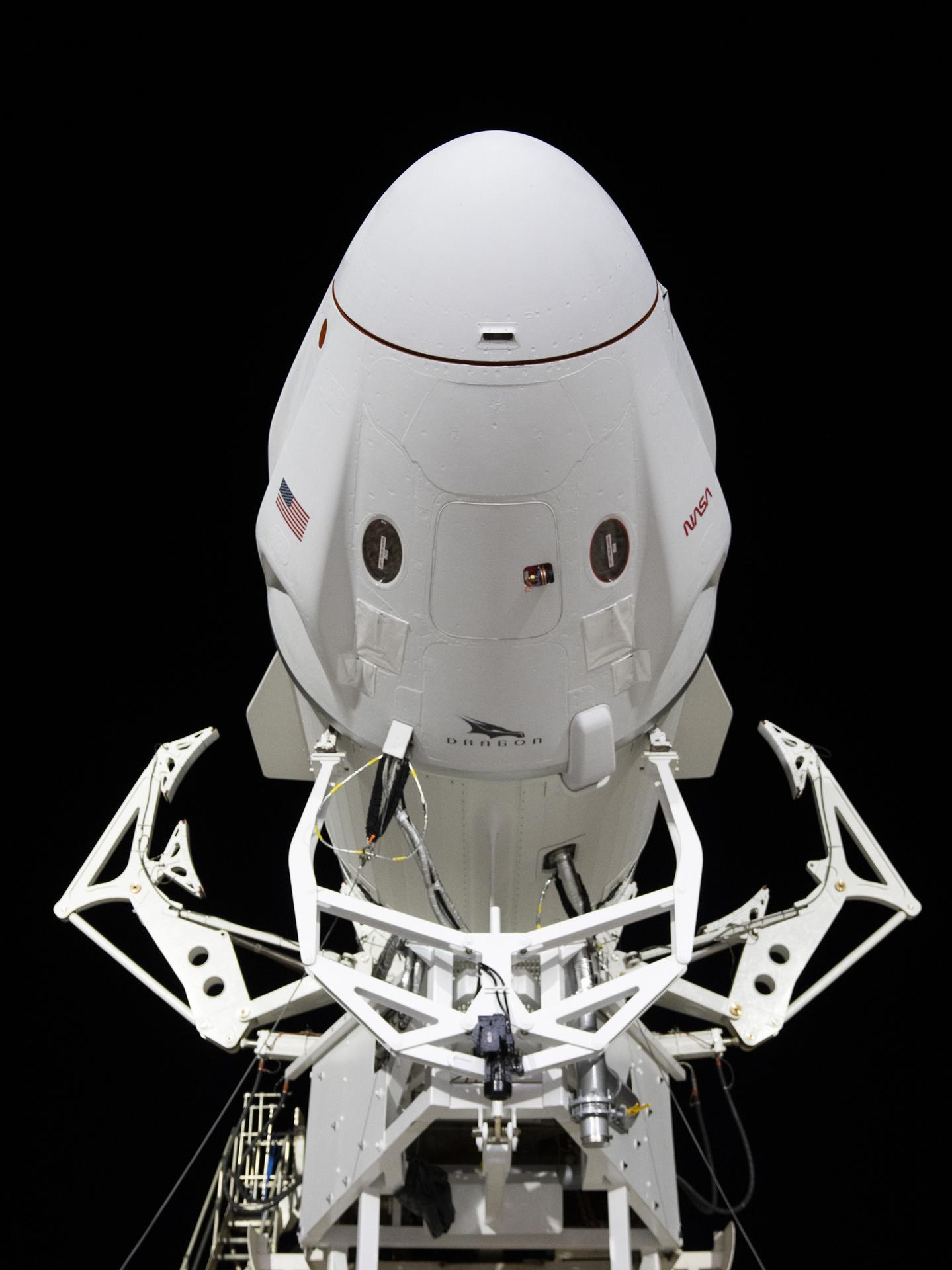 A close-up view of SpaceX's Dragon spacecraft as it prepares to roll horizontally to the launch pad.