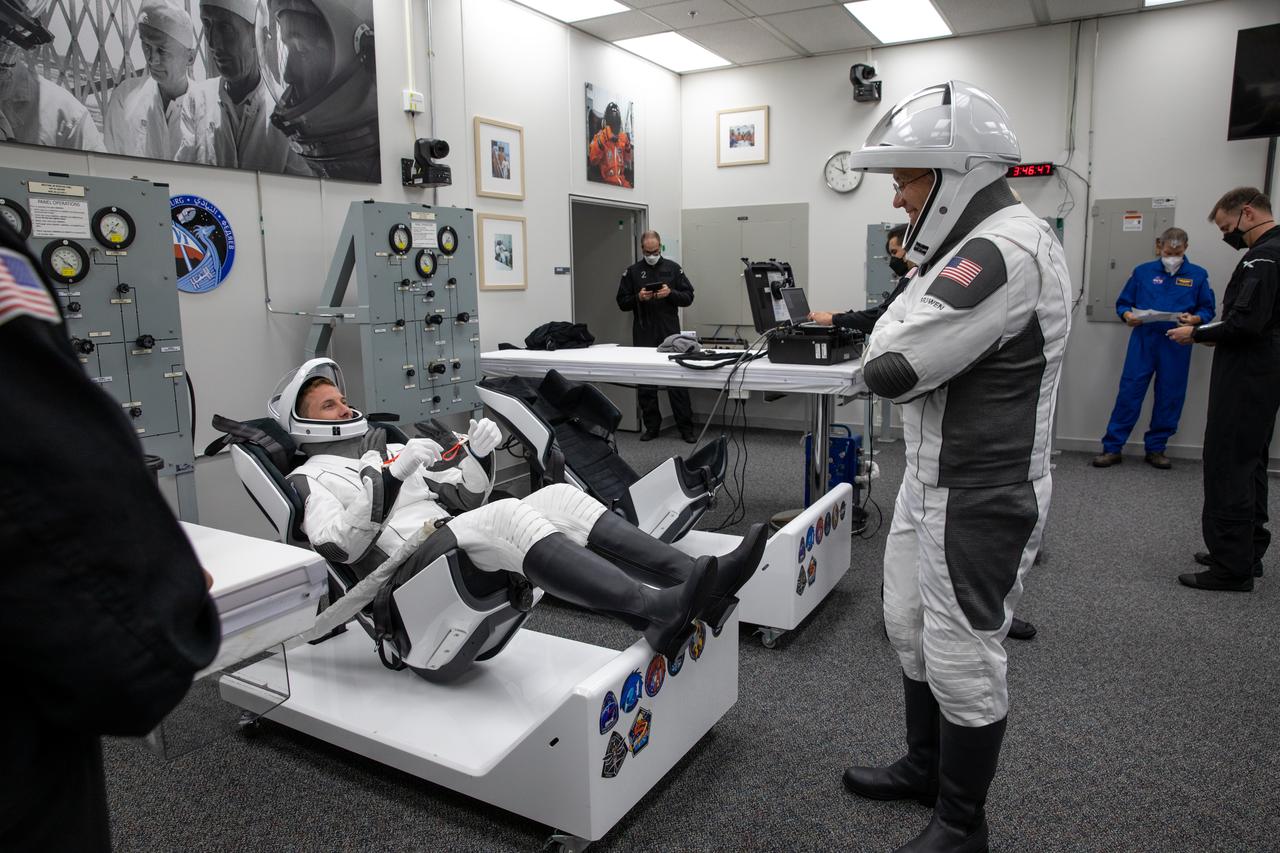 NASA astronaut and SpaceX Crew-6 commander Stephen Bowen, standing, and NASA astronaut Warren “Woody” Hoburg, pilot, check their spacesuits inside the crew suit-up room in the Neil Armstrong Operations and Checkout Building at NASA’s Kennedy Space Center in Florida during a countdown dress rehearsal on Feb. 23, 2023, to prepare for the upcoming Crew-6 launch. The Crew-6 astronauts will launch to the International Space Station aboard the Crew Dragon Endeavour on a SpaceX Falcon 9. Launch is targeted for 1:45 a.m. EST on Feb. 27 from Launch Complex 39A. Crew-6 is the sixth crew rotation mission with SpaceX to the station, and the seventh flight of Dragon with people as part of the agency’s Commercial Crew Program.