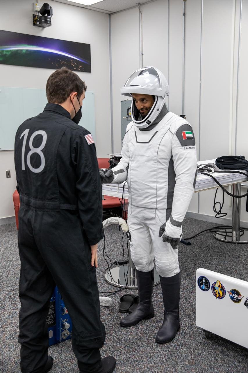 At right, Sultan Alneyadi, UAE (United Arab Emirates) astronaut and mission specialist, checks his spacesuit inside the crew suit-up room in the Neil Armstrong Operations and Checkout Building at NASA’s Kennedy Space Center in Florida during a countdown dress rehearsal on Feb. 23, 2023, to prepare for the upcoming Crew-6 launch. The Crew-6 astronauts will launch to the International Space Station aboard the Crew Dragon Endeavour on a SpaceX Falcon 9. Launch is targeted for 1:45 a.m. EST on Feb. 27 from Launch Complex 39A. Crew-6 is the sixth crew rotation mission with SpaceX to the station, and the seventh flight of Dragon with people as part of the agency’s Commercial Crew Program.