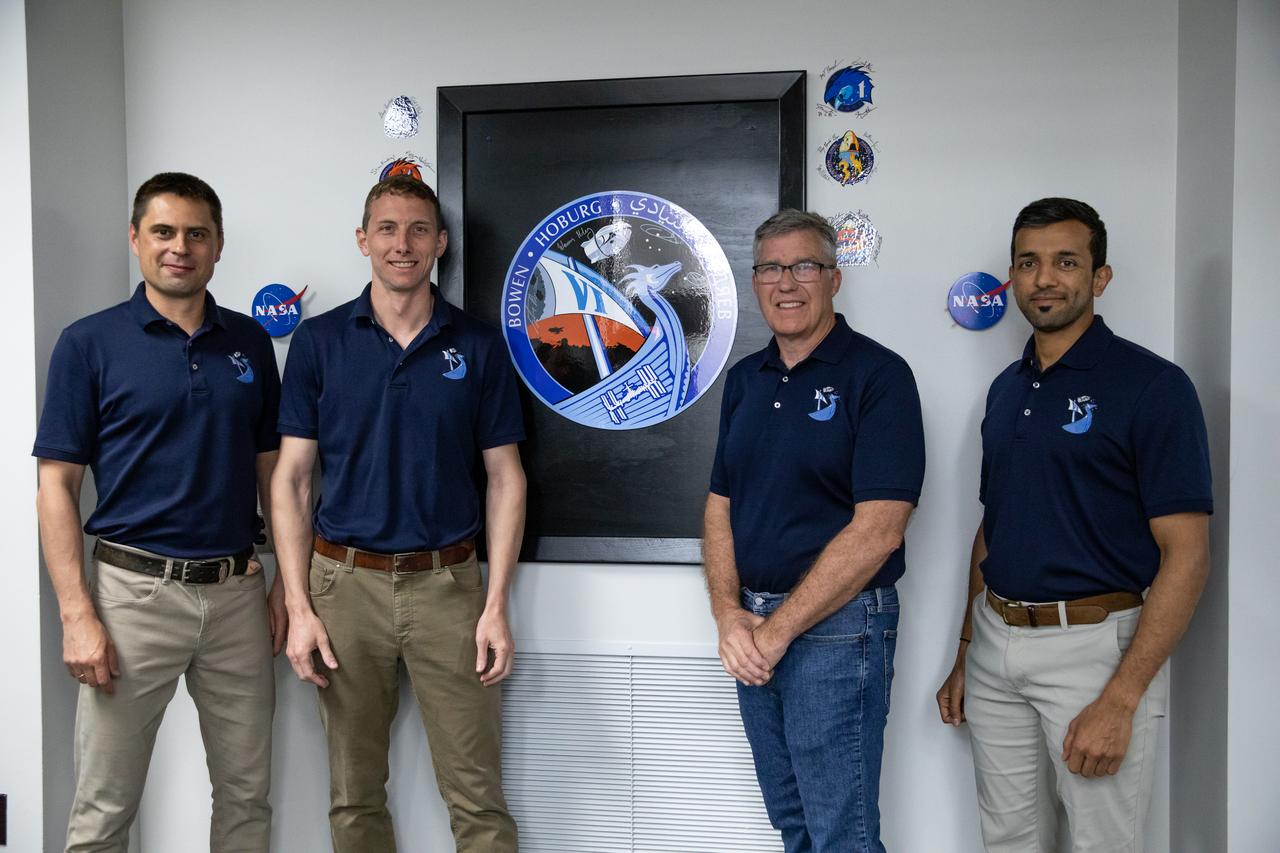 NASA’s SpaceX Crew-6 astronauts stand near the mission emblem in the astronaut crew quarters inside the Neil Armstrong Operations and Checkout Building at Kennedy Space Center in Florida on Feb. 26, 2023. From left are Andrey Fedyaev, Roscosmos cosmonaut and mission specialist; NASA astronaut Warren “Woody” Hoburg, pilot; NASA astronaut Stephen Bowen, spacecraft commander; and Sultan Alneyadi, UAE (United Arab Emirates) astronaut and mission specialist. The astronauts are preparing for their launch to the International Space Station aboard SpaceX’s Dragon spacecraft atop the Falcon 9 rocket. Launch was targeted for 1:45 a.m. EST on Feb. 27 from Launch Complex 39A, but was scrubbed for the day. Crew-6 is the sixth crew rotation mission with SpaceX to the station, and the seventh flight of Dragon with people as part of the agency’s Commercial Crew Program.