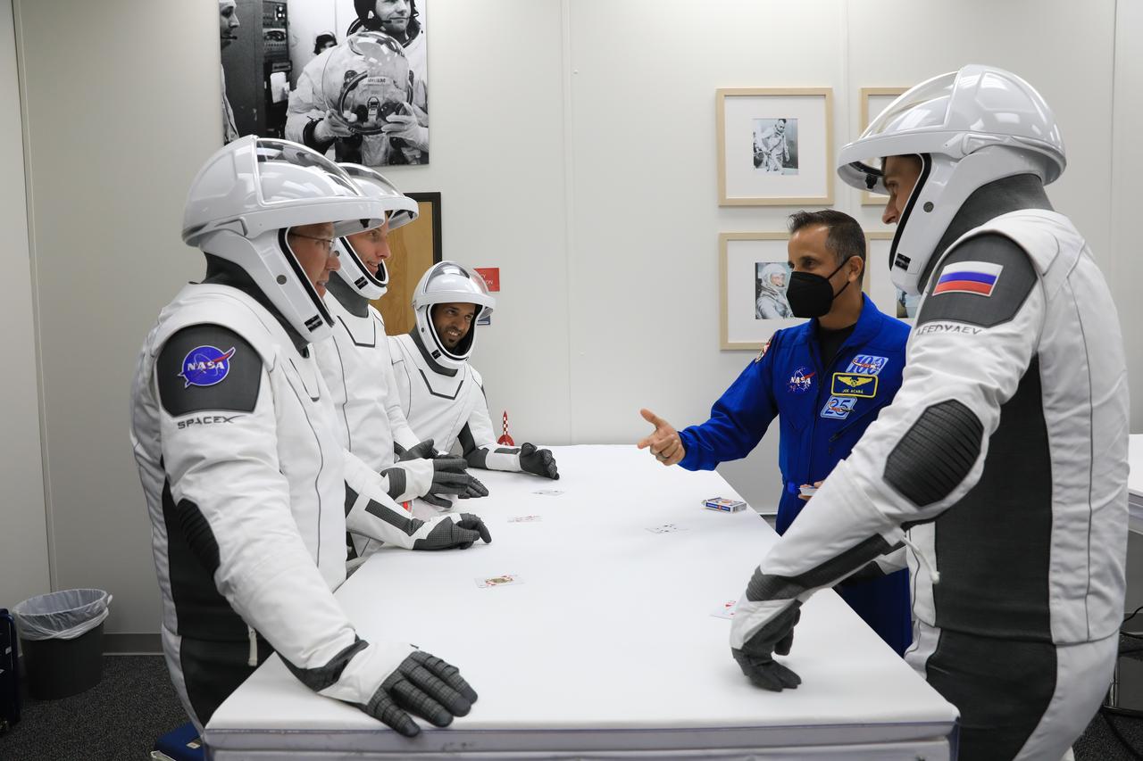 After suit-up and final fit checks, NASA’s SpaceX Crew-6 astronauts participate in a traditional game of cards inside the Neil Armstrong Operations and Checkout Building at NASA’s Kennedy Space Center crew in Florida on Feb. 26, 2023. At right, in front is Andrey Fedyaev, Roscosmos cosmonaut and mission specialist. On the opposite side of the table, from left are NASA astronaut Stephen Bowen, spacecraft commander; NASA astronaut Warren “Woody” Hoburg, pilot; and Sultan Alneyadi, UAE (United Arab Emirates) astronaut and mission specialist. The crewmembers are preparing for launch to the International Space Station aboard SpaceX’s Dragon spacecraft atop the Falcon 9 rocket. Launch was targeted for 1:45 a.m. EST on Feb. 27 from Launch Complex 39A, but was scrubbed for the day. Crew-6 is the sixth crew rotation mission with SpaceX to the station, and the seventh flight of Dragon with people as part of the agency’s Commercial Crew Program. 