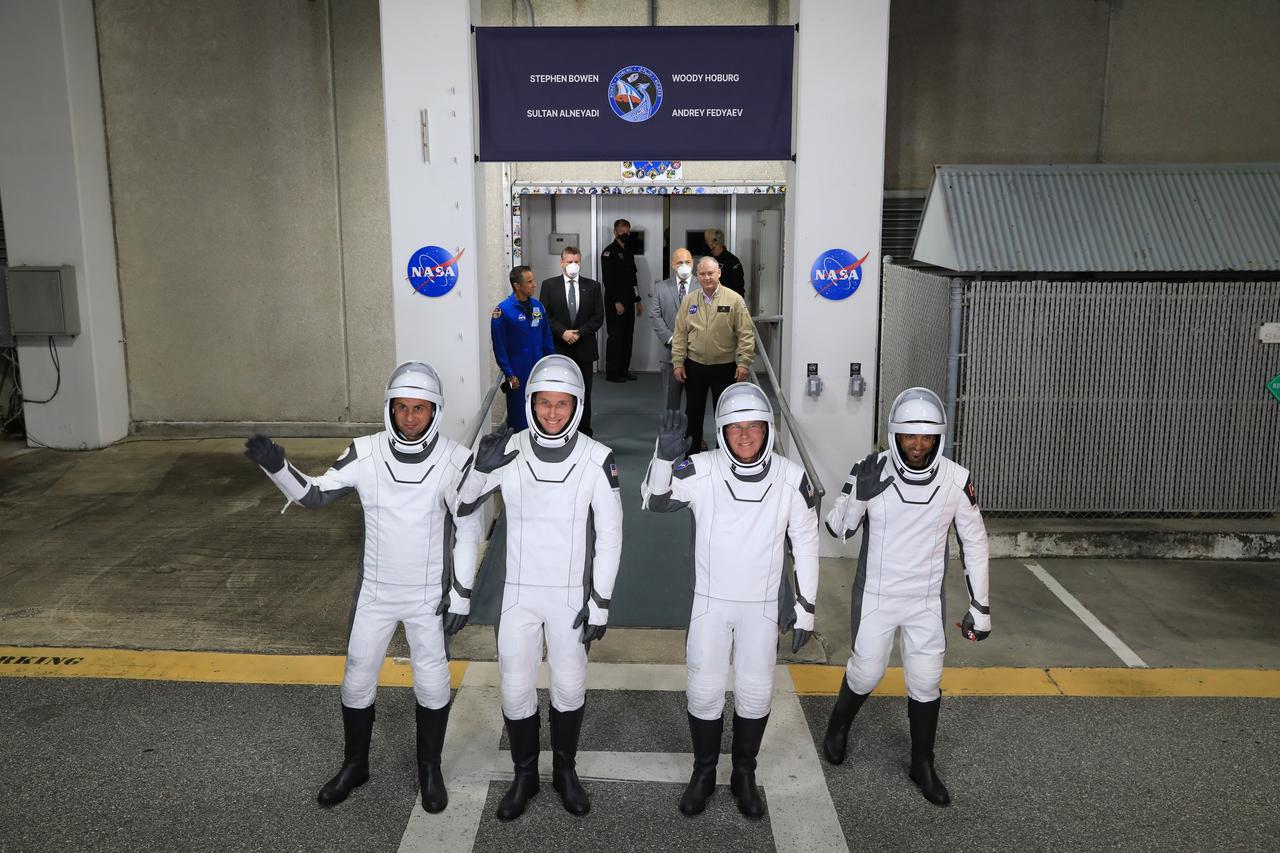 NASA’s SpaceX Crew-6 astronauts wave after walking out of the Neil Armstrong Operations and Checkout Building at the agency’s Kennedy Space Center in Florida on Feb. 26, 2023. From left are Andrey Fedyaev, Roscosmos cosmonaut and mission specialist; NASA astronaut Warren “Woody” Hoburg, pilot; NASA astronaut Stephen Bowen, spacecraft commander; and Sultan Alneyadi, UAE (United Arab Emirates) astronaut and mission specialist. They will board two Tesla vehicles for the trip to Kennedy’s Launch Complex 39A, where they will launch to the International Space Station aboard SpaceX’s Dragon Endeavour spacecraft. Launch was targeted for 1:45 a.m. EST on Feb. 27 from Launch Complex 39A, but was scrubbed for the day. Crew-6 is the sixth crew rotation mission with SpaceX to the station, and the seventh flight of Dragon with people as part of the agency’s Commercial Crew Program.