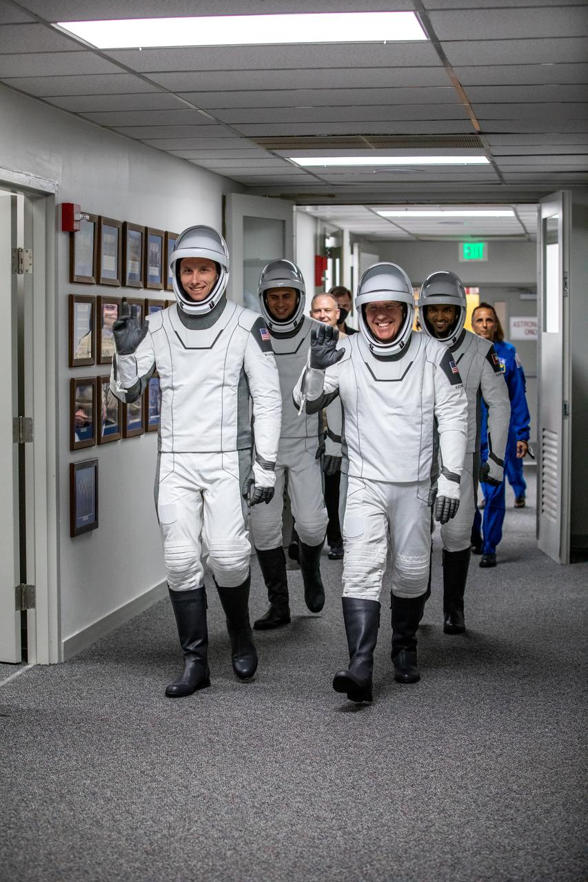 NASA’s SpaceX Crew-6 astronauts walk down the hallway from the astronaut crew quarters to the elevator in the Neil Armstrong Operations and Checkout Building at NASA’s Kennedy Space Center in Florida on March 1, 2023. In front, from left are NASA astronaut Warren Hoburg, pilot; and NASA astronaut Stephen Bowen, spacecraft commander. Behind them, from left are Andrey Fedyaev, Roscosmos cosmonaut and mission specialist; and Sultan Alneyadi, UAE (United Arab Emirates) astronaut and mission specialist. The astronauts are preparing for their launch to the International Space Station aboard SpaceX’s Dragon spacecraft Endeavour atop the Falcon 9 rocket. Launch is targeted for 12:34 a.m. EST on March 2 from Launch Complex 39A. Crew-6 is the sixth crew rotation mission with SpaceX to the station, and the seventh flight of Dragon with people as part of the agency’s Commercial Crew Program. 