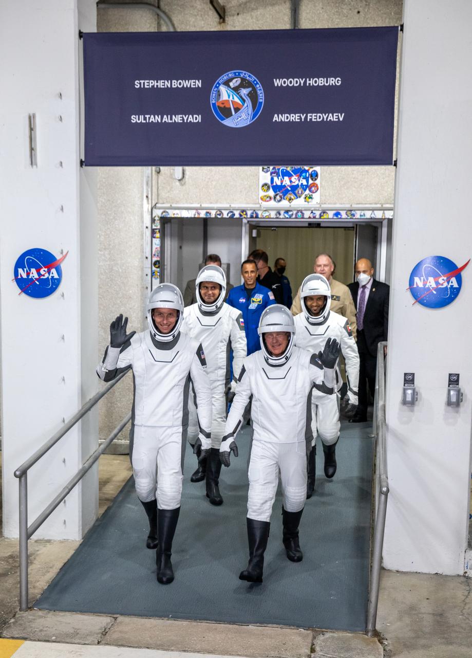 NASA’s SpaceX Crew-6 astronauts walk out of the Neil Armstrong Operations and Checkout Building at the agency’s Kennedy Space Center in Florida on March 1, 2023. In front, from left are NASA astronaut Warren “Woody” Hoburg, pilot; and NASA astronaut Stephen Bowen, spacecraft commander. Behind them, from left are Andrey Fedyaev, Roscosmos cosmonaut and mission specialist; and Sultan Alneyadi, UAE (United Arab Emirates) astronaut and mission specialist. They will board two Tesla vehicles for the trip to Kennedy’s Launch Complex 39A, where they will launch to the International Space Station aboard SpaceX’s Dragon Endeavour spacecraft. SpaceX’s Falcon 9 rocket is scheduled to launch at 12:34 a.m. EST on March 2 from Launch Complex 39A. Crew-6 is the sixth crew rotation mission with SpaceX to the station, and the seventh flight of Dragon with people as part of the agency’s Commercial Crew Program. 