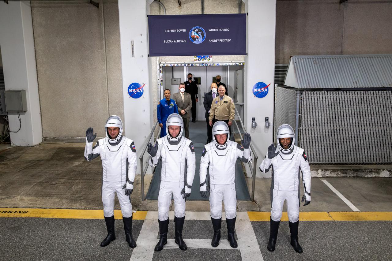 NASA’s SpaceX Crew-6 astronauts wave after walking out of the Neil Armstrong Operations and Checkout Building at the agency’s Kennedy Space Center in Florida on March 1, 2023. From left are Andrey Fedyaev, Roscosmos cosmonaut and mission specialist; NASA astronaut Warren Hoburg, pilot; NASA astronaut Stephen Bowen, spacecraft commander; and Sultan Alneyadi, UAE (United Arab Emirates) astronaut and mission specialist. They will board two Tesla vehicles for the trip to Kennedy’s Launch Complex 39A, where they will launch to the International Space Station aboard SpaceX’s Dragon Endeavour spacecraft. Launch is targeted for 12:34 a.m. EST on March 2 from Launch Complex 39A. Crew-6 is the sixth crew rotation mission with SpaceX to the station, and the seventh flight of Dragon with people as part of the agency’s Commercial Crew Program. 
