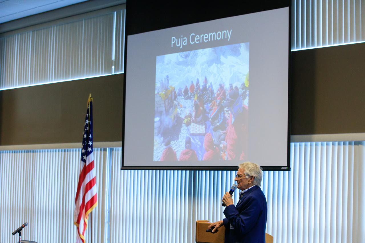 Arthur Muir, a retired Chicago attorney and America’s oldest Mt. Everest summiteer, addresses the audience during the inaugural Cross-Program Connection event at NASA Kennedy Space Center’s Space Station Processing Facility on March 8, 2023. Muir, 75, was the speaker at the Florida spaceport function titled “Explorers Doing the Impossible.” He toured Kennedy before sharing his experiences in overcoming incredible challenges during his journey to the top of Earth’s highest mountain.