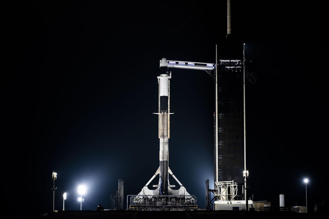 A SpaceX Falcon 9 rocket, with the company’s Dragon spacecraft atop, is raised to a vertical position at NASA Kennedy Space Center’s Launch Complex 39A on March 13, 2023, in preparation for the 27th commercial resupply services launch to the International Space Station. The mission will deliver new science investigations, supplies, and equipment to the crew aboard the space station, including the final two experiments comprising the National Institutes for Health and International Space Station National Laboratory’s Tissue Chips in Space initiative, Cardinal Heart 2.0 and Engineered Heart Tissues-2. Liftoff is scheduled for 8:30 p.m. EDT on Tuesday, March 14, from Kennedy’s Launch Complex 39A.
