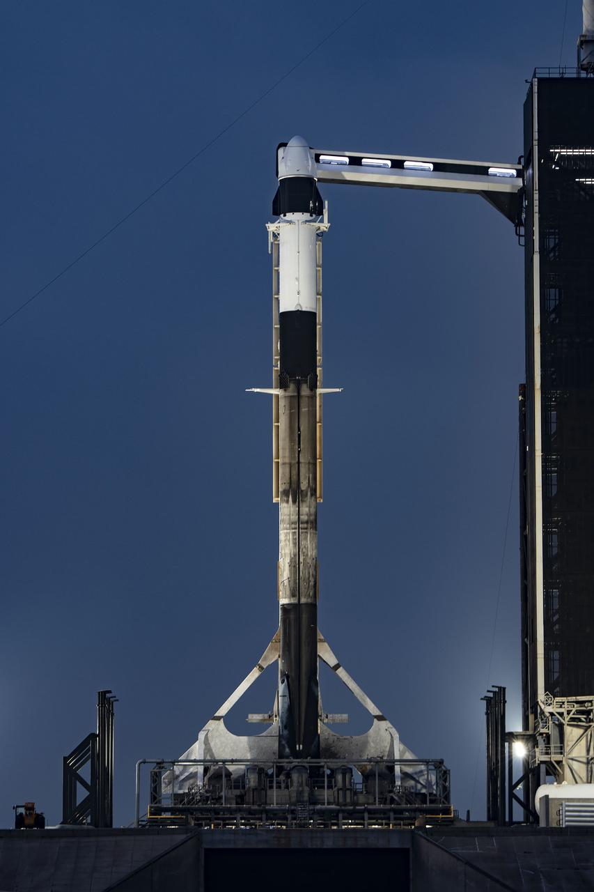 A SpaceX Falcon 9 rocket, with the company’s Dragon spacecraft atop, is secured in the vertical position at NASA Kennedy Space Center’s Launch Complex 39A on March 13, 2023, in preparation for the 27th commercial resupply services launch to the International Space Station. The mission will deliver new science investigations, supplies, and equipment to the crew aboard the space station, including the final two experiments comprising the National Institutes for Health and International Space Station National Laboratory’s Tissue Chips in Space initiative, Cardinal Heart 2.0 and Engineered Heart Tissues-2. Liftoff is scheduled for 8:30 p.m. EDT on Tuesday, March 14, from Kennedy’s Launch Complex 39A.