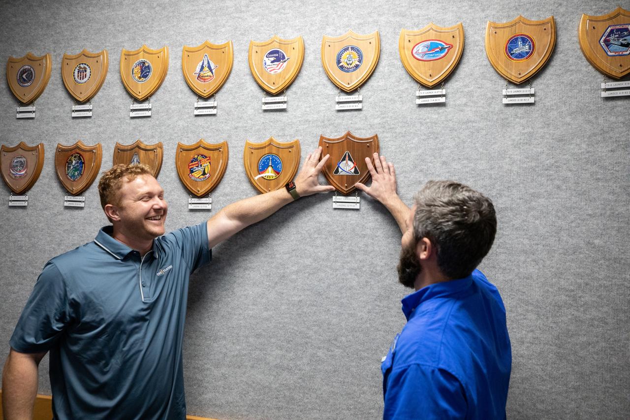 The Artemis plaque is attached to the wall in Firing Room 1 of the Launch Control Center at NASA’s Kennedy Space Center in Florida during a ceremony on March 24, 2023. Hanging the plaque on the wall are Elliot Payne (left) and Devin Aikman (right), members of the Arms and Umbilicals engineering team. The first in a series of increasingly complex missions, Artemis I launched successfully from Kennedy’s Launch Pad 39B at 1:47 a.m. EST on Nov. 16, 2022.