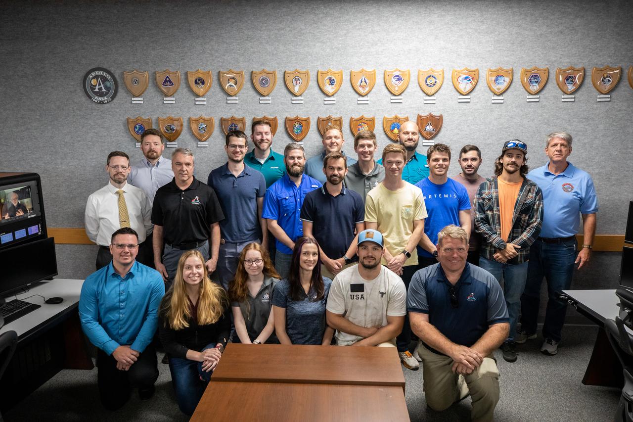 The Arms and Umbilicals (AUS) engineering team gather for a photograph during the Artemis launch director awards and plaque ceremony inside Firing Room 1 of the Launch Control Center at NASA’s Kennedy Space Center in Florida on March 24, 2023. Following tradition from the Apollo and Space Shuttle Programs, the AUS teams hung the Artemis I mission plaque to the wall behind them. The first in a series of increasingly complex missions, Artemis I launched successfully from Kennedy’s Launch Pad 39B at 1:47 a.m. EST on Nov. 16, 2022. 
