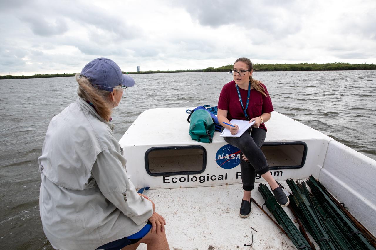 Kennedy Space Center Public Affairs Writer Danielle Sempsrott (right) interviews Jane Provancha, manager of the ecological group for NASA’s Environmental and Medical Contract (NEMCON) at Kennedy, for a web feature highlighting seagrass restoration efforts taking place at the Florida spaceport on March 29, 2023. Kennedy’s Environmental Management Branch is working to plant a minimum of 28,000 shoots of seagrass divided into 18 sites across three areas at the Florida spaceport as part of a pilot project for seagrass restoration efforts. The project will look at the feasibility of replanting seagrass in Kennedy waters and, if successful, could lead to the spaceport becoming a donor site where shoots of grass can be broken off and relocated to other areas within Kennedy or along the Indian River Lagoon to promote growth.