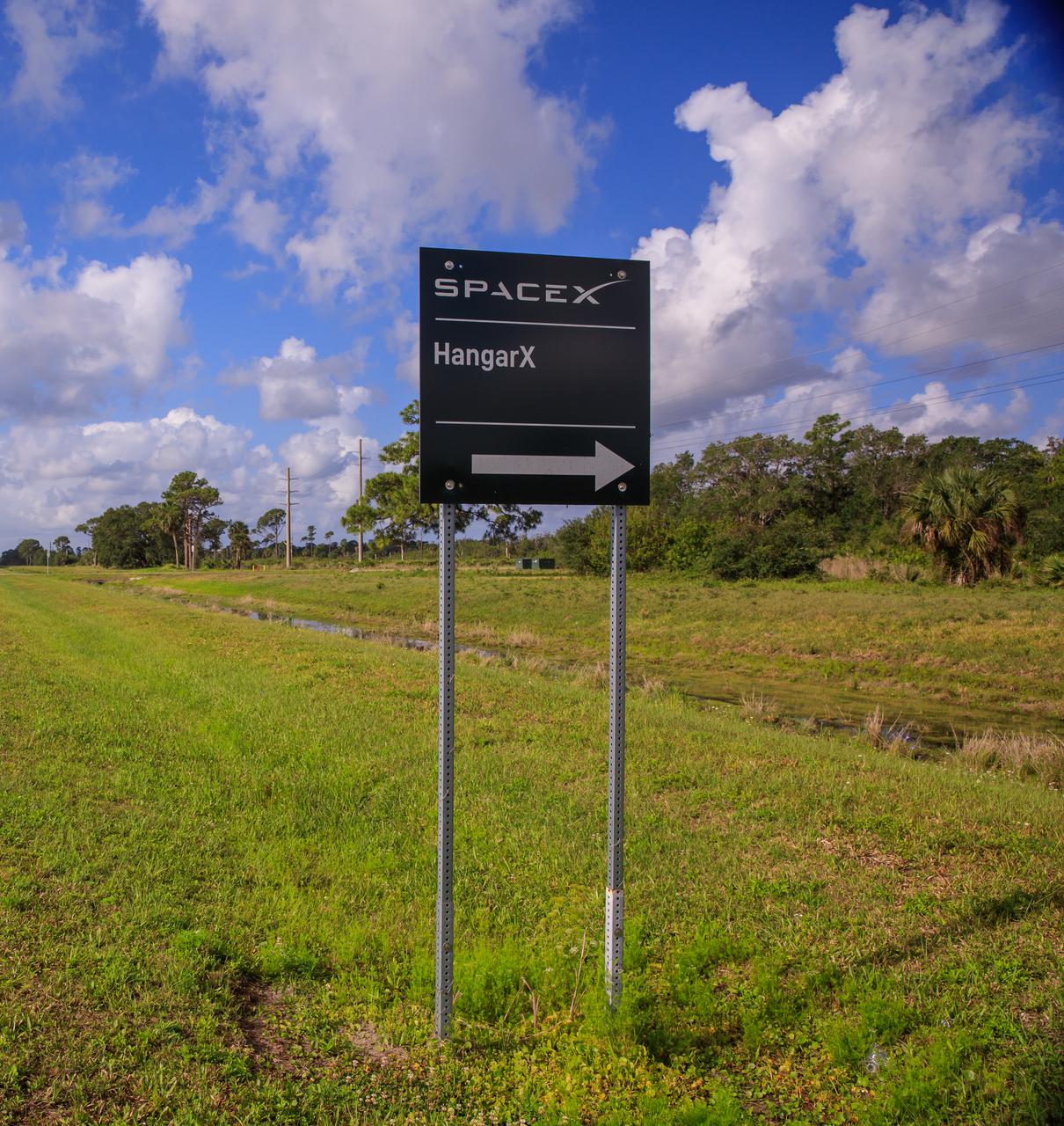 A sign marks the entrance to SpaceX’s Roberts Road off of State Road 3 at NASA’s Kennedy Space Center in Florida on April 21, 2023. The company wishes to extend the road to allow for expansion of its current facilities. An environmental impact study is underway to investigate the feasibility of the campus expansion.