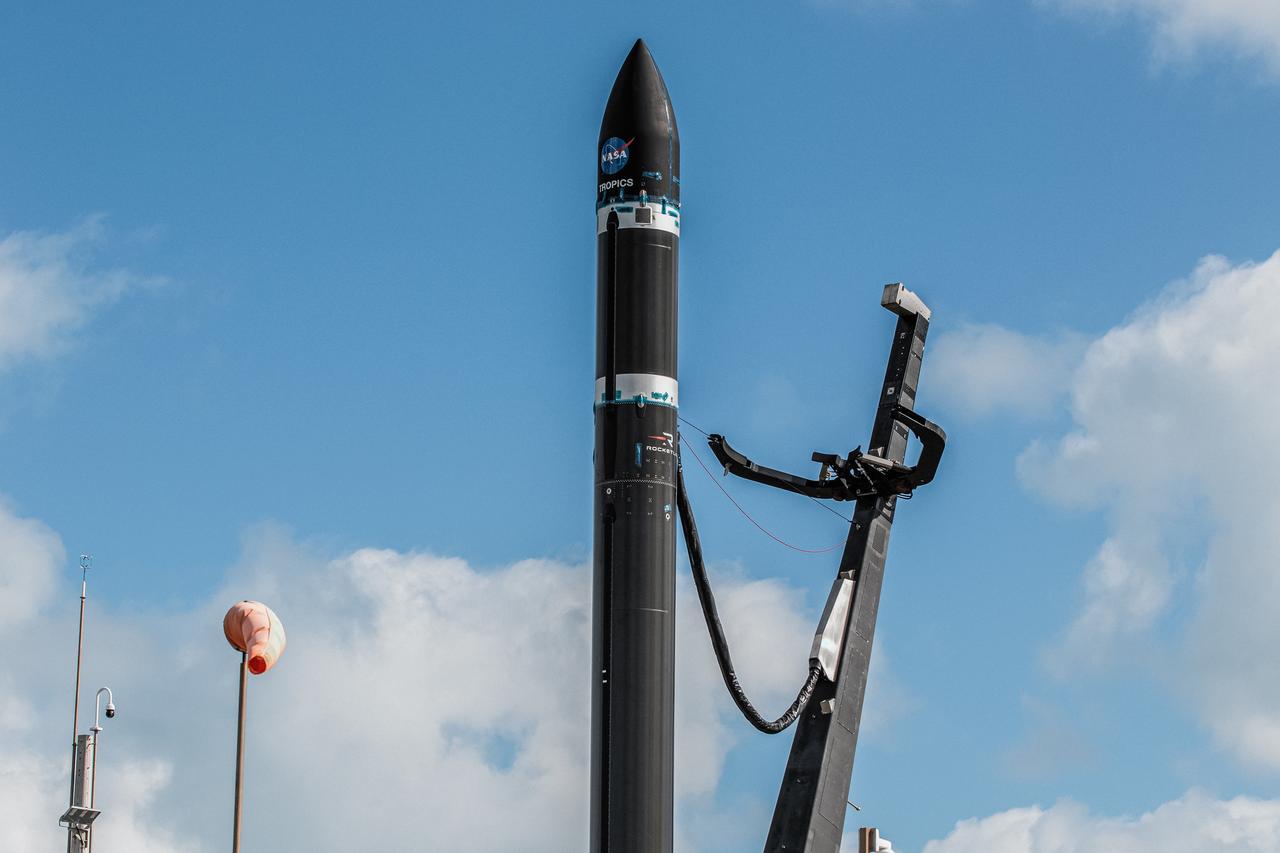 With the umbilical tower in view, Rocket Lab’s Electron rocket is vertical on the pad at Launch Complex 1 in Mahia, New Zealand. NASA’s Time-Resolved Observations of Precipitation structure and storm Intensity with a Constellation of Smallsats (TROPICS) CubeSats are secured in the payload fairing atop the rocket. TROPICS is scheduled to launch on Monday, May 1, at 1 a.m. New Zealand time from Launch Complex 1, Pad B. TROPICS will provide data on temperature, precipitation, water vapor, and clouds by measuring microwave frequencies, providing insight into storm formation and intensification. 