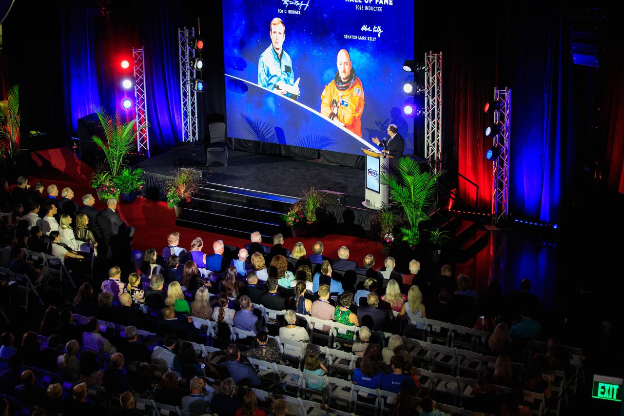 Howard Schwartz, Kennedy Space Center Visitor Complex vice president of Operations and Guest Engagement, speaks to guests during the 2023 U.S. Astronaut Hall of Fame (AHOF) Induction inside the Space Shuttle Atlantis attraction at the Kennedy Space Center Visitor Complex on May 6, 2023. Two veteran space explorers were inducted into the AHOF Class of 2023. They are Roy D. Bridges Jr. and Mark Kelly. Inductees into the Hall of Fame are selected by a committee of Hall of Fame astronauts, former NASA officials, flight directors, historians and journalists. The process is administered by the Astronaut Scholarship Foundation. To be eligible, an astronaut must have made his or her first flight at least 17 years before the induction. Candidates must be a U.S. citizen and a NASA-trained commander, pilot, or mission specialist who has orbited the earth at least once. Including Bridges and Kelly, 107 astronauts have been inducted into the AHOF.