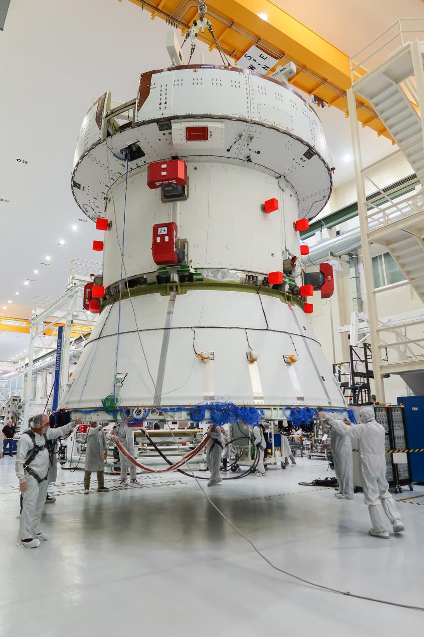 The European Service Module (ESM) for NASA’s Artemis II mission is lifted by crane and moved along the center aisle of the high bay inside the Neil A. Armstrong Operations and Checkout Building at NASA’s Kennedy Space Center in Florida on May 22, 2023. Teams from NASA and Lockheed Martin are preparing the service module for transfer to the FAST (final assembly and system testing) cell for final checkouts before it is stacked with the Orion crew module.. The powerhouse that will fuel and propel Orion in space, the ESM will be used for Artemis II, the first Artemis mission flying crew aboard Orion. 