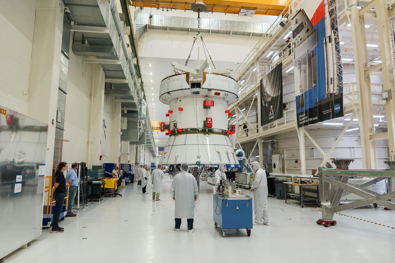 A crane moves the European Service Module (ESM) for NASA’s Artemis II mission along the center aisle of the high bay inside the Neil A. Armstrong Operations and Checkout Building at NASA’s Kennedy Space Center in Florida on May 22, 2023. Teams from NASA and Lockheed Martin are preparing the service module for transfer to the FAST (final assembly and system testing) cell for final checkouts before it is stacked with the Orion crew module.. The powerhouse that will fuel and propel Orion in space, the ESM will be used for Artemis II, the first Artemis mission flying crew aboard Orion. 