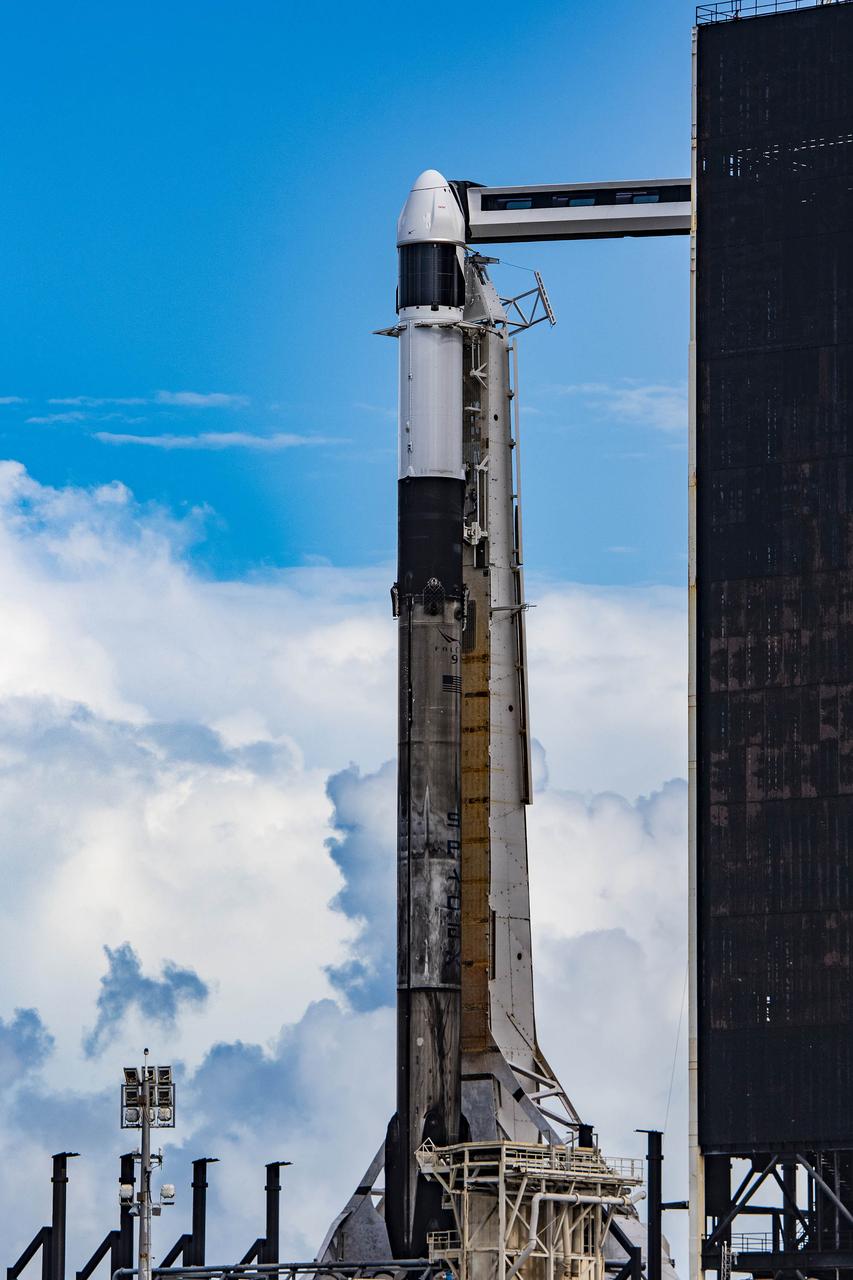 Blue sky and clouds serve as a backdrop for the SpaceX Falcon 9 rocket with the Dragon spacecraft atop on the pad at Launch Complex 39A at NASA’s Kennedy Space Center in Florida on June 2, 2023. SpaceX is scheduled to launch its 28th commercial resupply services mission to the International Space Station for NASA. Launch is scheduled for June 3 at 12:35 p.m. EDT. Dragon will deliver approximately 7,000 pounds of crew supplies, equipment, and science experiments to the orbiting laboratory. The spacecraft is expected to spend about a month attached to the orbiting outpost before it returns to Earth with research and return cargo, splashing down off the coast of Florida.