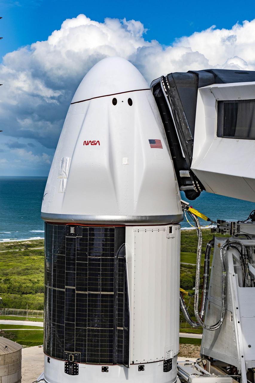 A close-up view of the SpaceX Dragon spacecraft atop the Falcon 9 rocket with the access arm extended on the pad at Launch Complex 39A at NASA’s Kennedy Space Center in Florida on June 2, 2023. SpaceX is scheduled to launch its 28th commercial resupply services mission to the International Space Station for NASA. Launch is scheduled for June 3 at 12:35 p.m. EDT. Dragon will deliver approximately 7,000 pounds of crew supplies, equipment, and science experiments to the orbiting laboratory. The spacecraft is expected to spend about a month attached to the orbiting outpost before it returns to Earth with research and return cargo, splashing down off the coast of Florida.