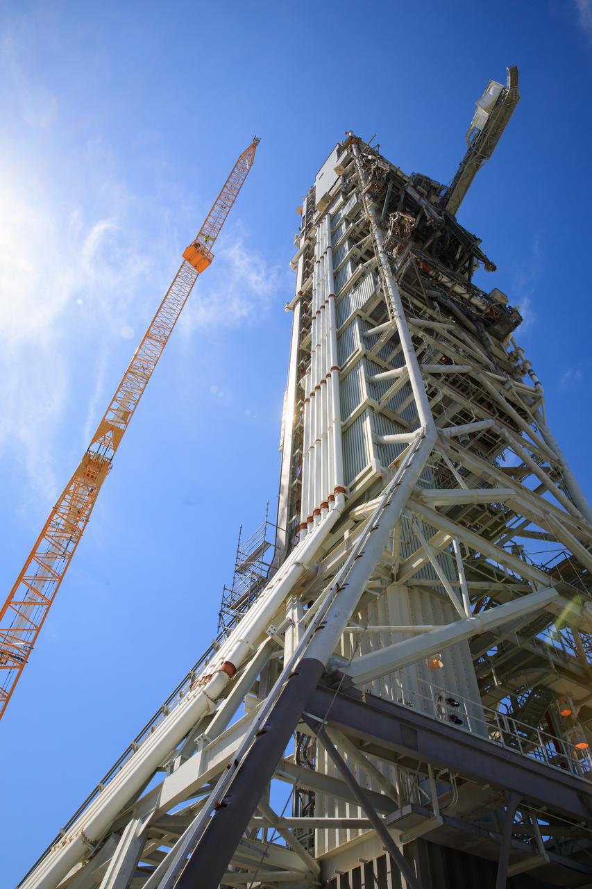Teams with Exploration Ground Systems at NASA’s Kennedy Space Center in Florida continue to work the upgrades and repairs on mobile launcher 1 and Launch Pad 39B on June 13, 2023, ahead of the first critical ground testing for Artemis II.  The crew access arm (CAA) has been extended in this view of the mobile launcher. The CAA is the entry and exit point astronauts will use for access to the Orion spacecraft. Tests will be conducted to ensure the arm and supporting mobile launcher systems are certified to support crewed missions. Artemis II will be the first Artemis mission flying crew aboard Orion. 