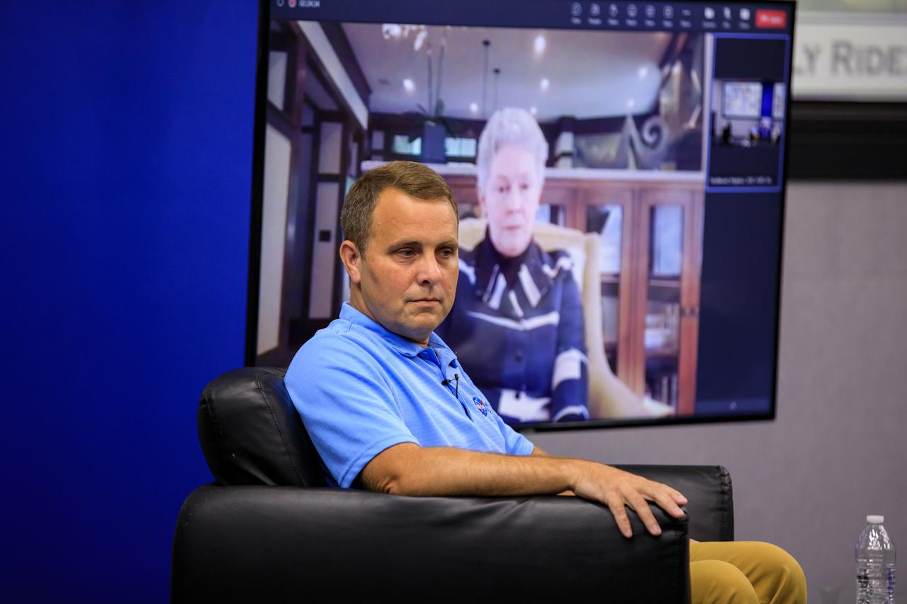 NASA Chief Historian Brian Odom moderates “The Legacy of Sally Ride: The First American Woman in Space” event at Kennedy Space Center in Florida on June 15, 2023. Forty years ago, Ride made her trailblazing flight into space. A hero to millions, Ride was a steadfast advocate for inclusion in STEM (science, technology, engineering, mathematics) – especially for girls and young women – until her death in 2012 from pancreatic cancer. Appearing on the monitor in the background is Sally Ride’s life partner of 27 years, Tam O’Shaughnessy.