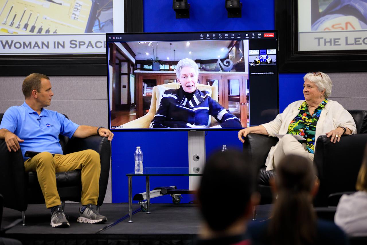 Tam O’Shaughnessy, center (on the monitor), speaks during “The Legacy of Sally Ride: The First American Woman in Space” event at Kennedy Space Center in Florida on June 15, 2023. O’Shaughnessy was Ride’s lifetime partner for 27 years, until the pioneering astronaut died in 2012 at age 61 from pancreatic cancer. NASA Chief Historian Brian Odom, left, and Bear Ride, Sally Ride’s sister, also participated in the event. Forty years ago, Ride made her trailblazing flight into space. She also was a physicist and a steadfast advocate for inclusion in STEM (science, technology, engineering, mathematics) – especially for girls and young women.