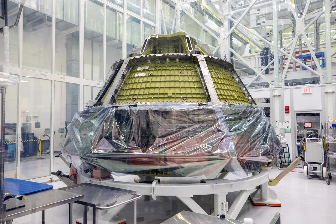 A protective wrapping is being removed from the Orion spacecraft for the Artemis III mission inside a clean room in the high bay of the Neil Armstrong Operations and Checkout Building at NASA’s Kennedy Space Center in Florida on June 22, 2023. The Orion spacecraft is being prepared for its launch atop the Space Launch System rocket on Artemis III, which will send astronauts, including the first woman and first person of color, on a mission to the surface of the Moon. 