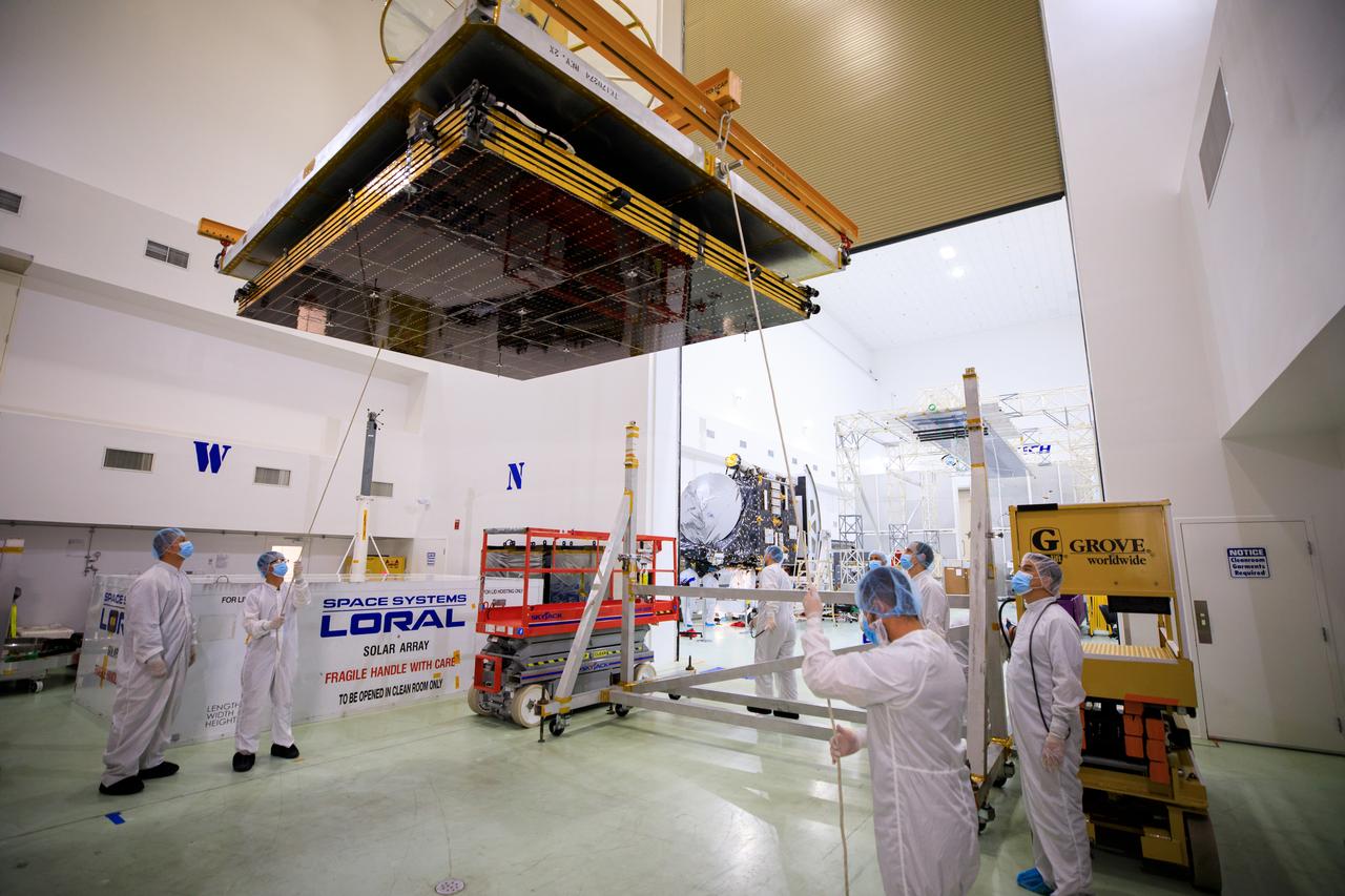 A NASA team assists as a crane is used to move the twin solar arrays for the agency’s Psyche spacecraft along the high bay inside the Astrotech Space Operations Facility near the agency’s Kennedy Space Center in Florida on July 18, 2023. The solar arrays were shipped from Maxar Technologies, in San, Jose, California. They are part of the solar electric propulsion system, provided by Maxar, that will power the spacecraft on its journey to explore a metal-rich asteroid. Psyche will launch atop a SpaceX Falcon Heavy rocket from Launch Complex 39A at Kennedy. Launch is targeted for Oct. 5, 2023. Riding with Psyche is a pioneering technology demonstration, NASA’s Deep Space Optical Communications (DSOC) experiment.