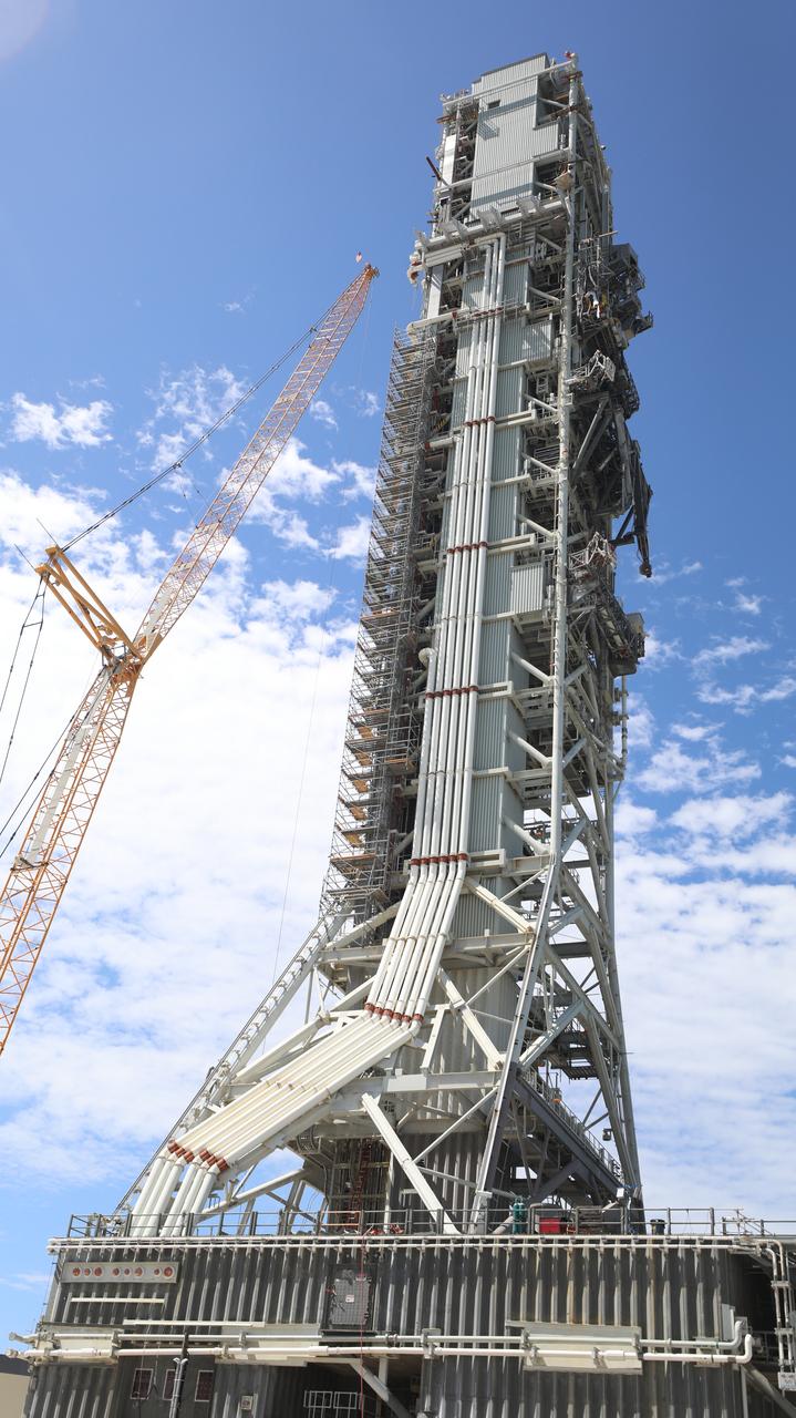 Teams with Exploration Ground Systems at NASA’s Kennedy Space Center in Florida make upgrades and repairs on mobile launcher 1 at its park site location on July 20, 2023, ahead of the first critical ground testing for Artemis II. Under Artemis, the mobile launcher will transport NASA’s Space Launch System rocket and Orion spacecraft to Kennedy’s Launch Complex 39B for liftoff. Artemis II will be the first Artemis mission flying crew aboard Orion.