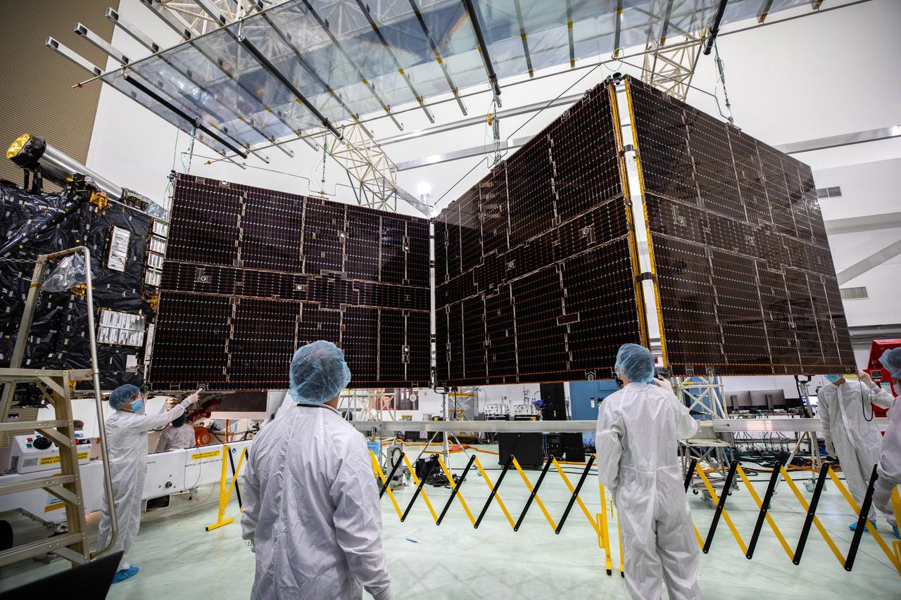 Technicians begin to retract one of the two solar arrays attached to NASA’s Psyche spacecraft inside the Astrotech Space Operations Facility near the agency’s Kennedy Space Center in Florida on July 25, 2023. The solar arrays, which were shipped from Maxar Technologies, in San Jose, California, are being stowed for launch. They are part of the solar electric propulsion system, provided by Maxar, that will power the spacecraft on its journey to explore a metal-rich asteroid. Psyche will launch atop a SpaceX Falcon Heavy rocket from Launch Complex 39A at Kennedy. Launch is targeted for Oct. 5, 2023. Riding with Psyche is a pioneering technology demonstration, NASA’s Deep Space Optical Communications (DSOC) experiment. 