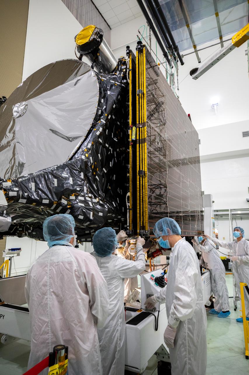 Team members retract the two solar arrays attached to NASA’s Psyche spacecraft inside the Astrotech Space Operations Facility near the agency’s Kennedy Space Center in Florida on July 25, 2023. The solar arrays, which were shipped from Maxar Technologies, in San Jose, California, are being stowed for launch. They are part of the solar electric propulsion system, provided by Maxar, that will power the spacecraft on its journey to explore a metal-rich asteroid. Psyche will launch atop a SpaceX Falcon Heavy rocket from Launch Complex 39A at Kennedy. Launch is targeted for Oct. 5, 2023. Riding with Psyche is a pioneering technology demonstration, NASA’s Deep Space Optical Communications (DSOC) experiment. 